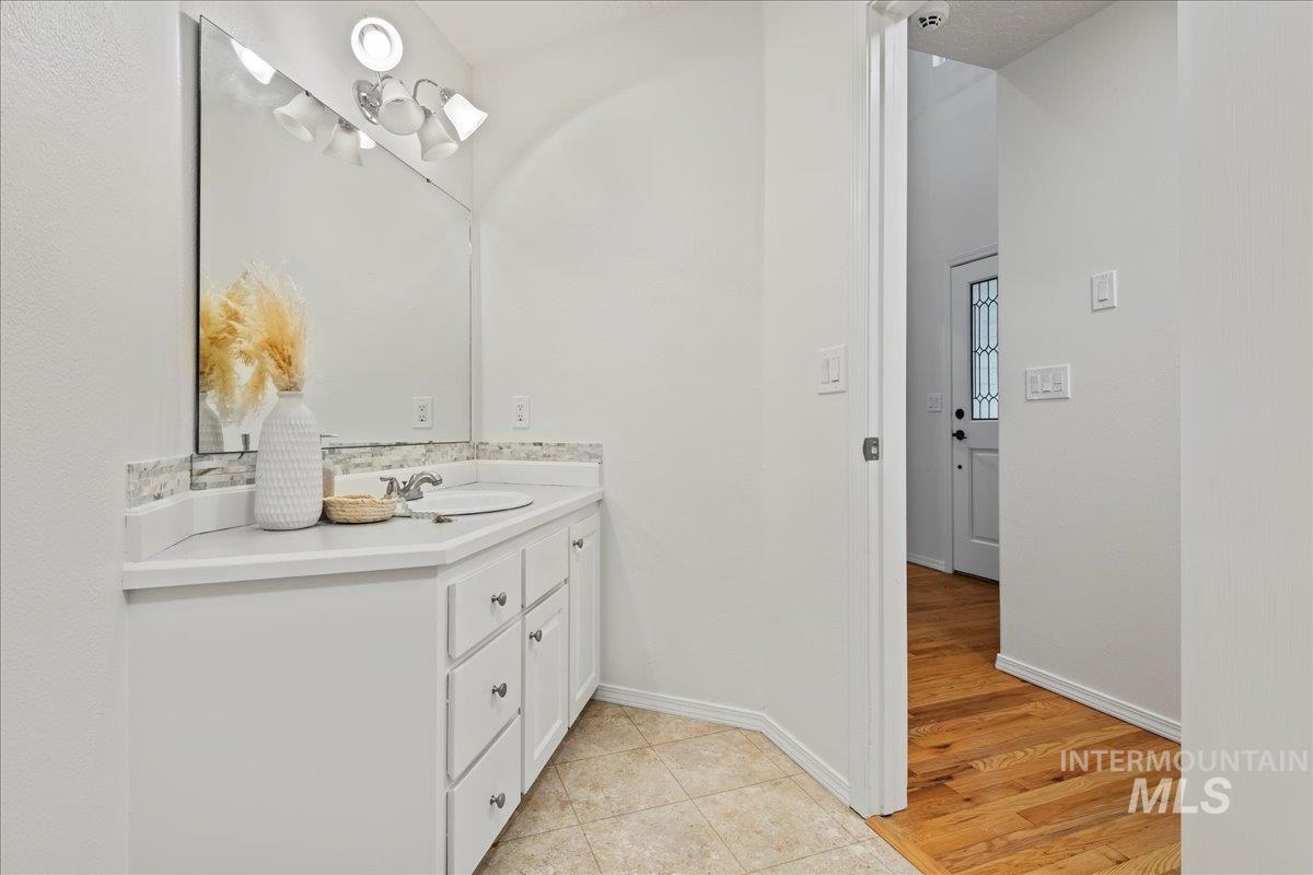 Bathroom with vanity and light wood-style floors