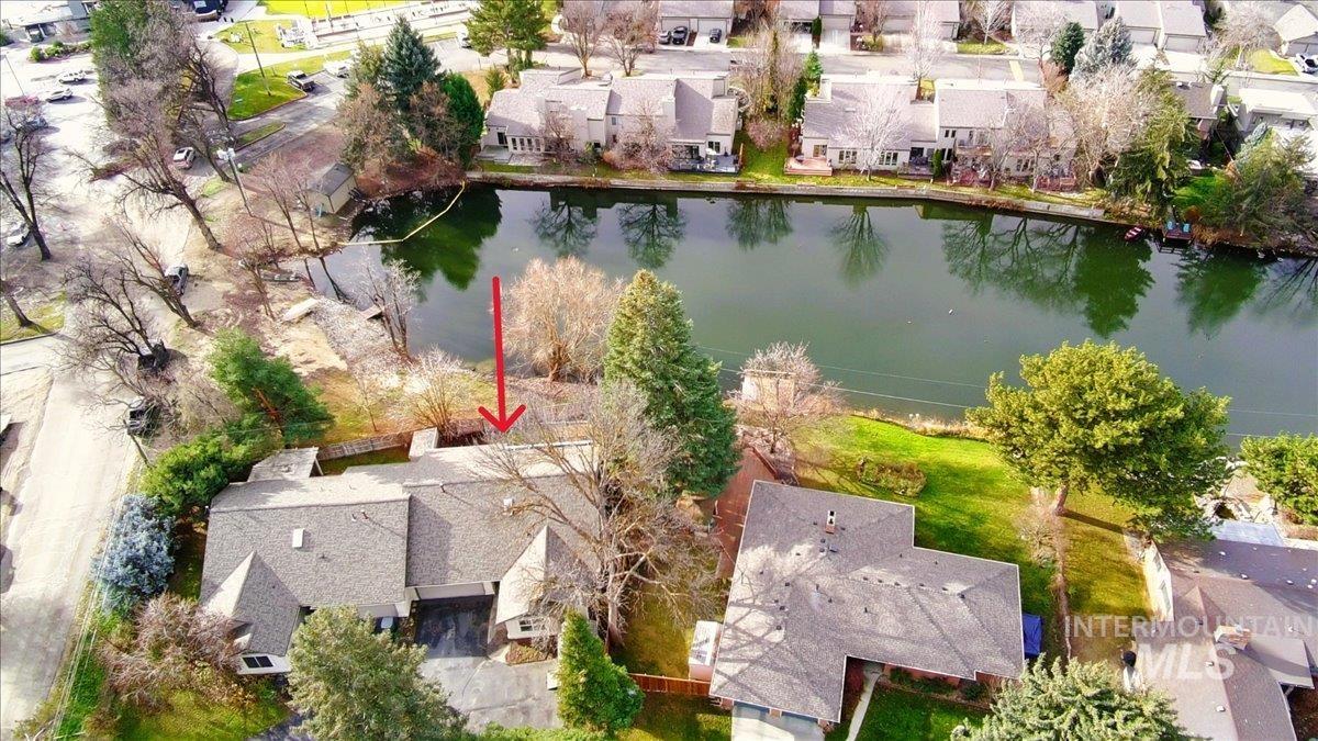 Aerial perspective of suburban area featuring a nearby body of water