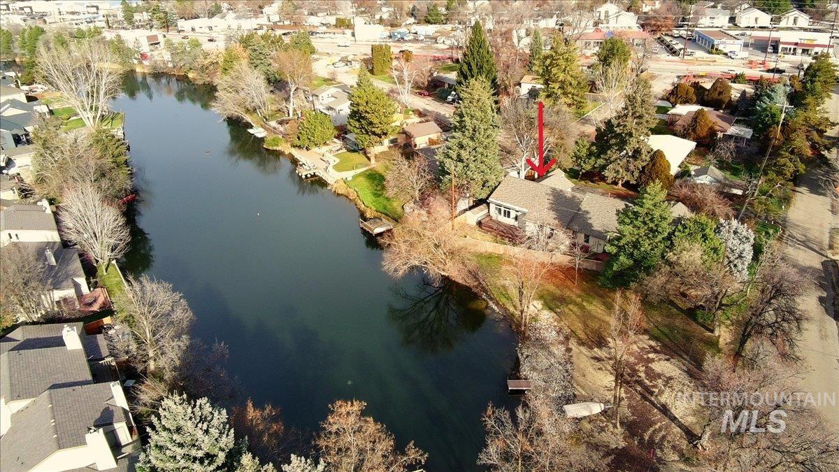 Aerial view of residential area featuring a nearby body of water
