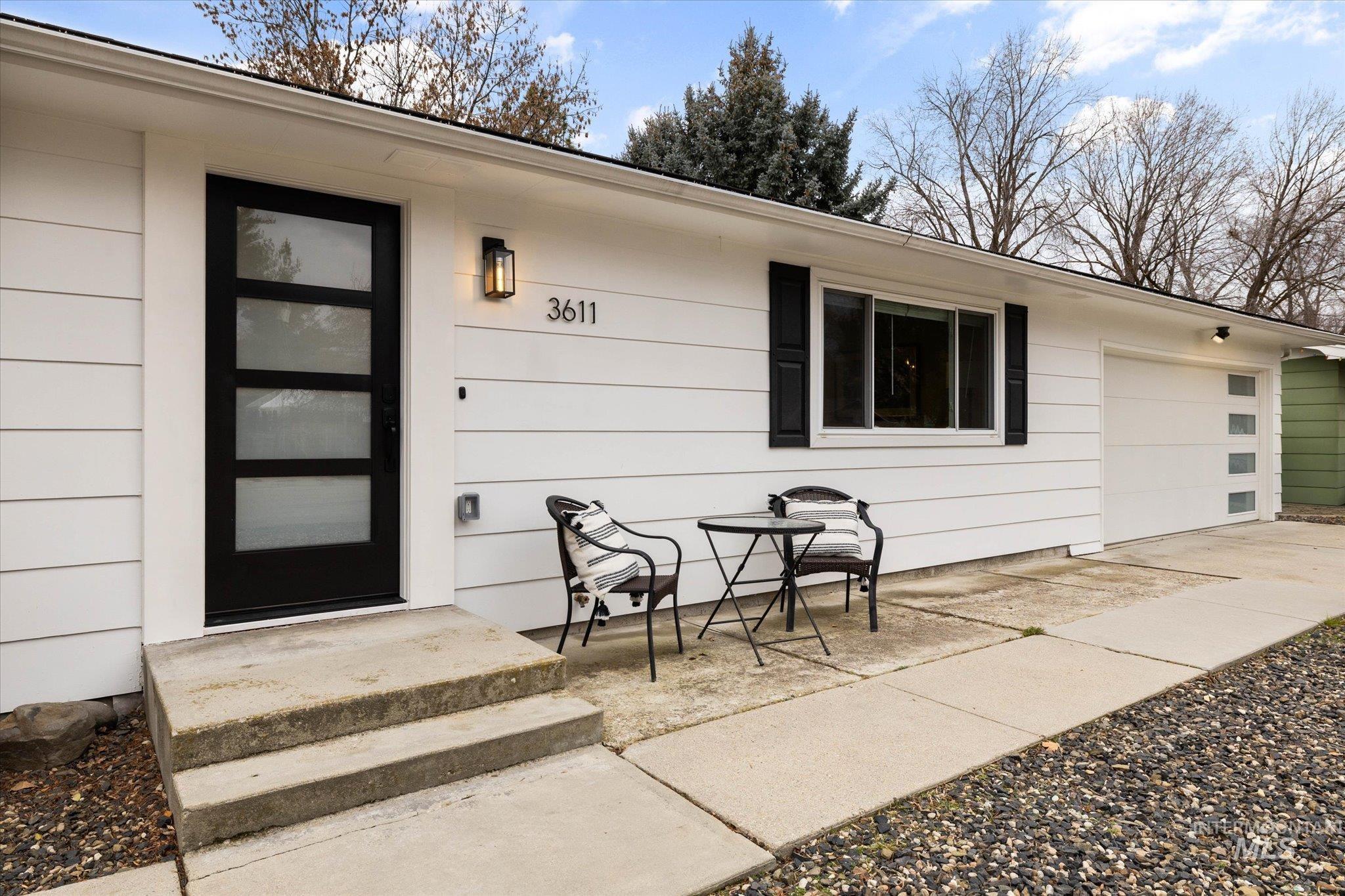 Property entrance featuring a garage and driveway