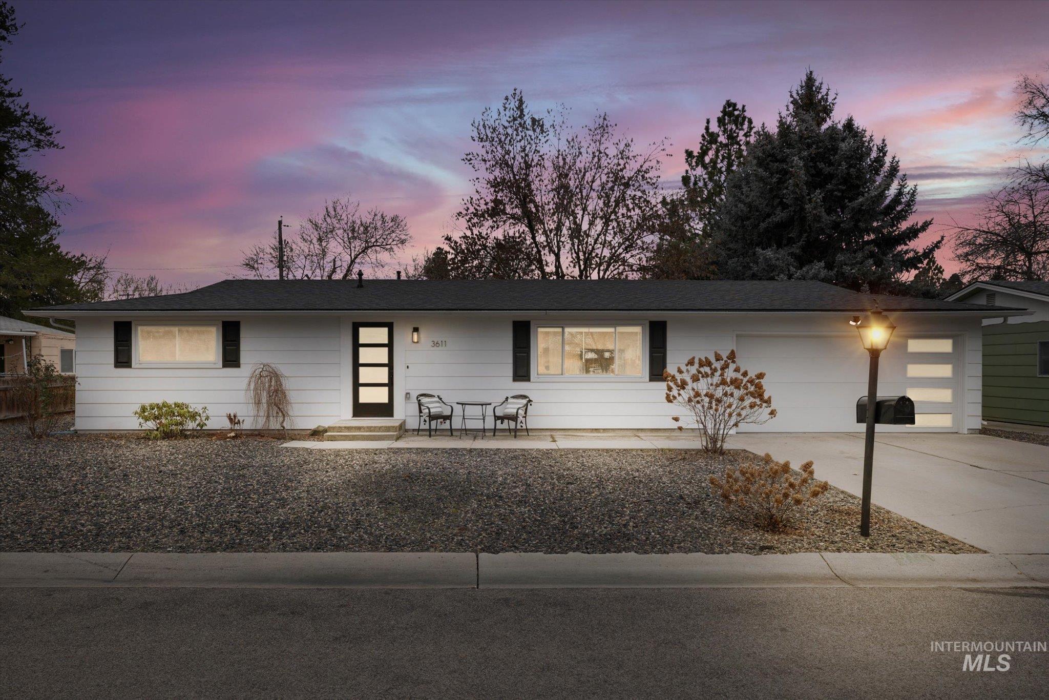 Single story home featuring concrete driveway and an attached garage