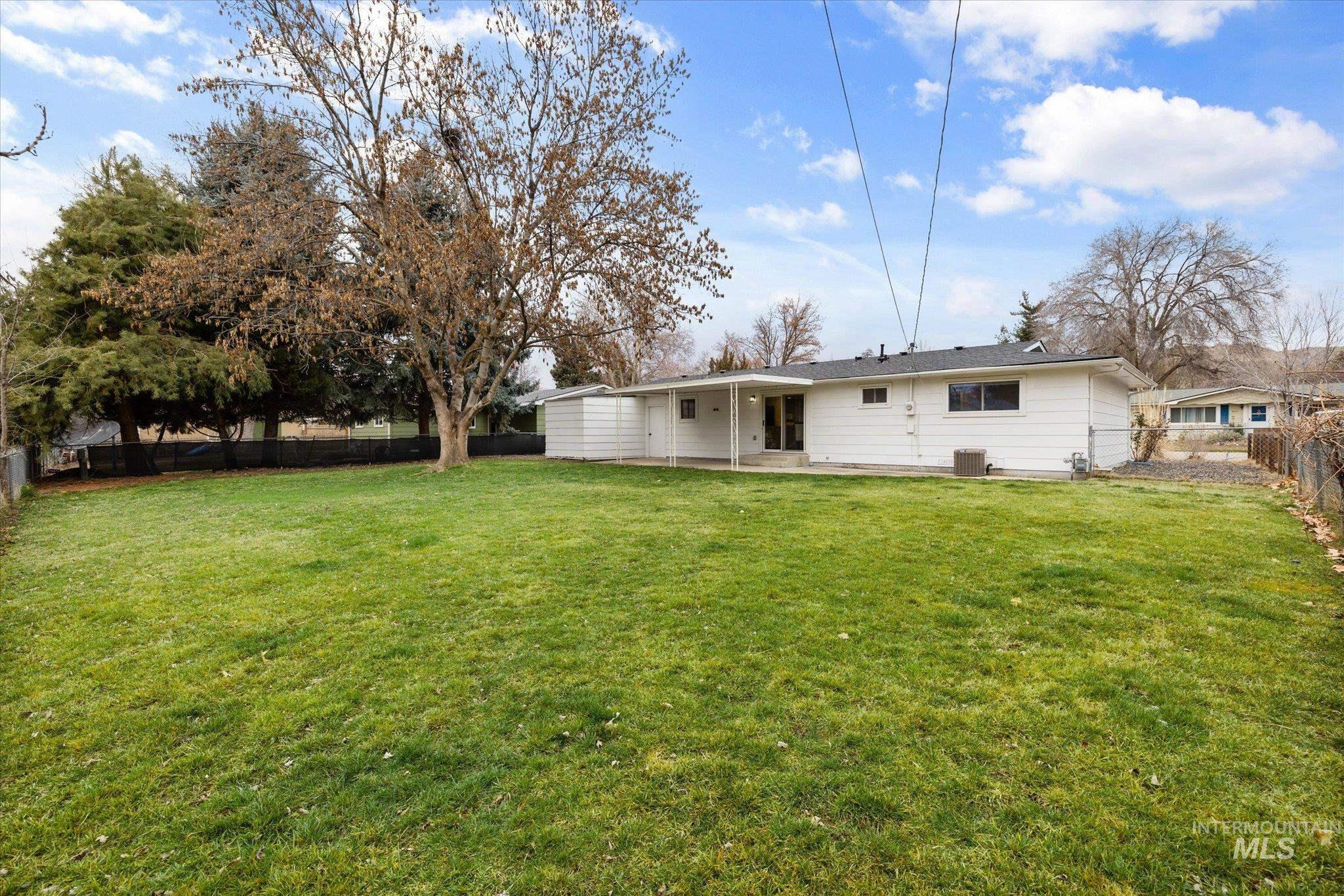 Rear view of house with a patio and a fenced backyard