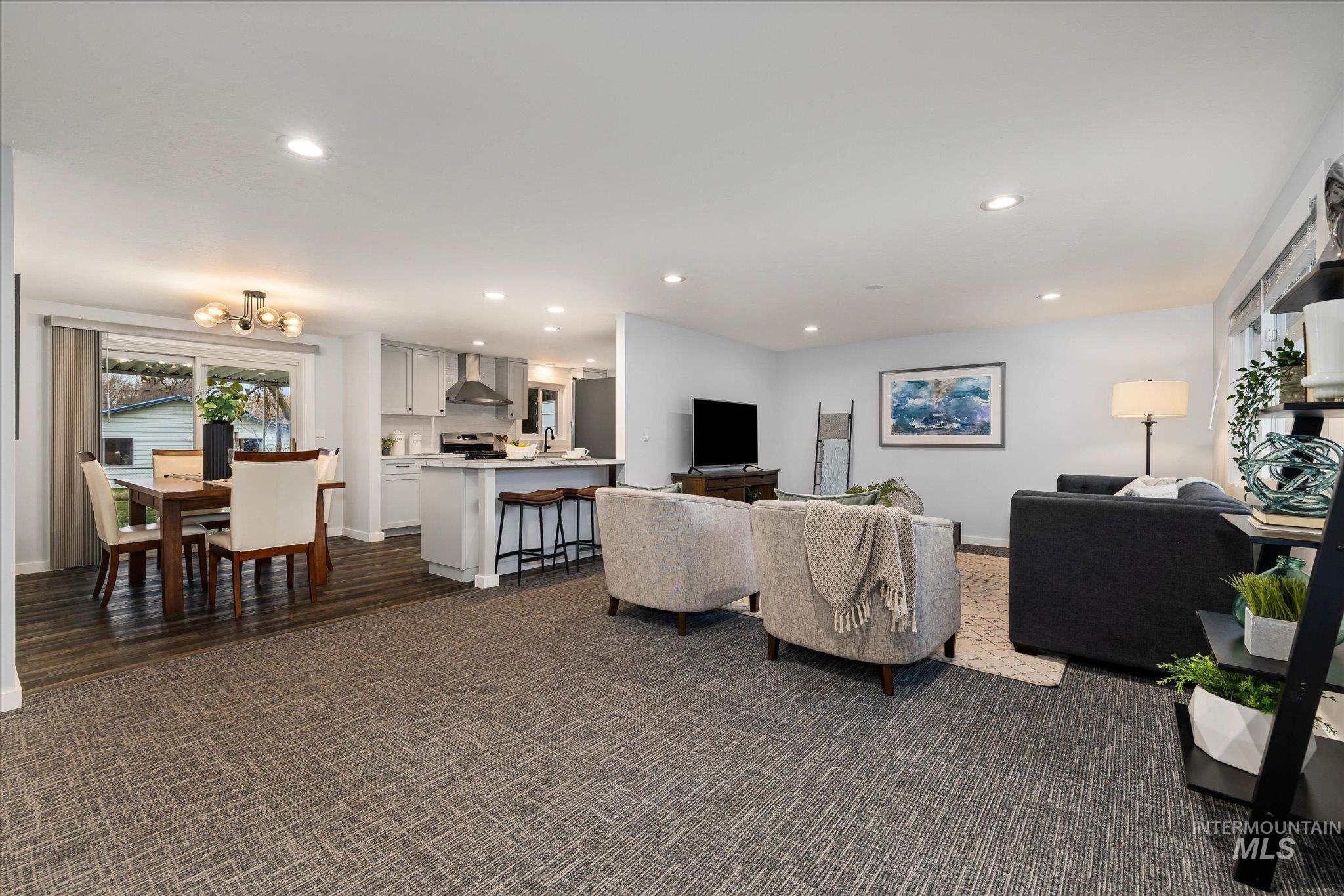 Living area featuring recessed lighting and dark colored carpet