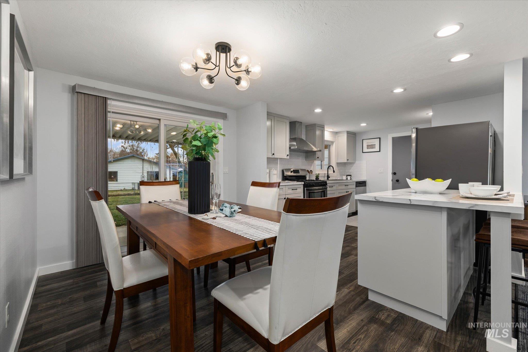 Dining room featuring dark wood-type flooring and suspended lighting