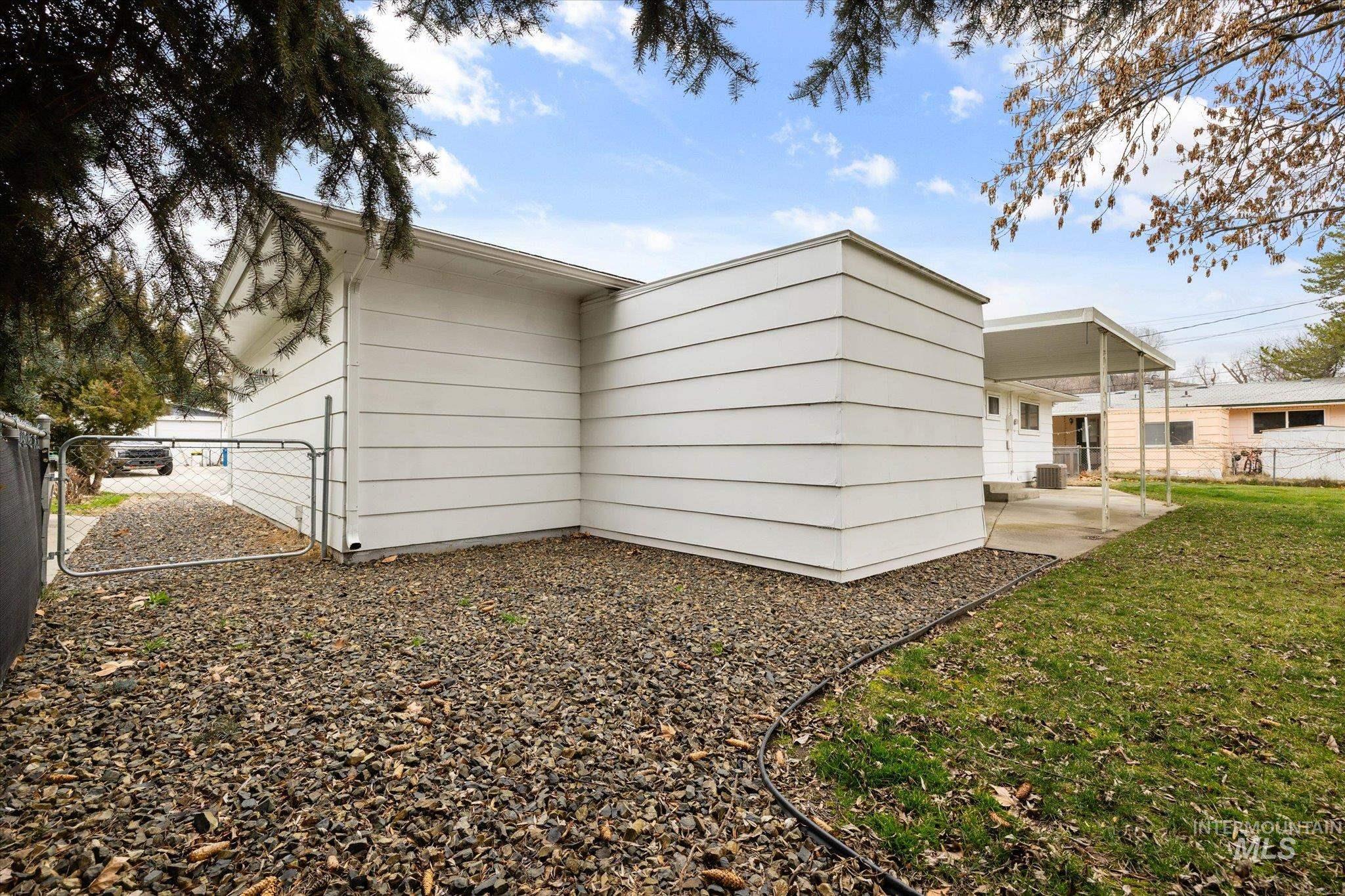 View of side of property featuring a gate