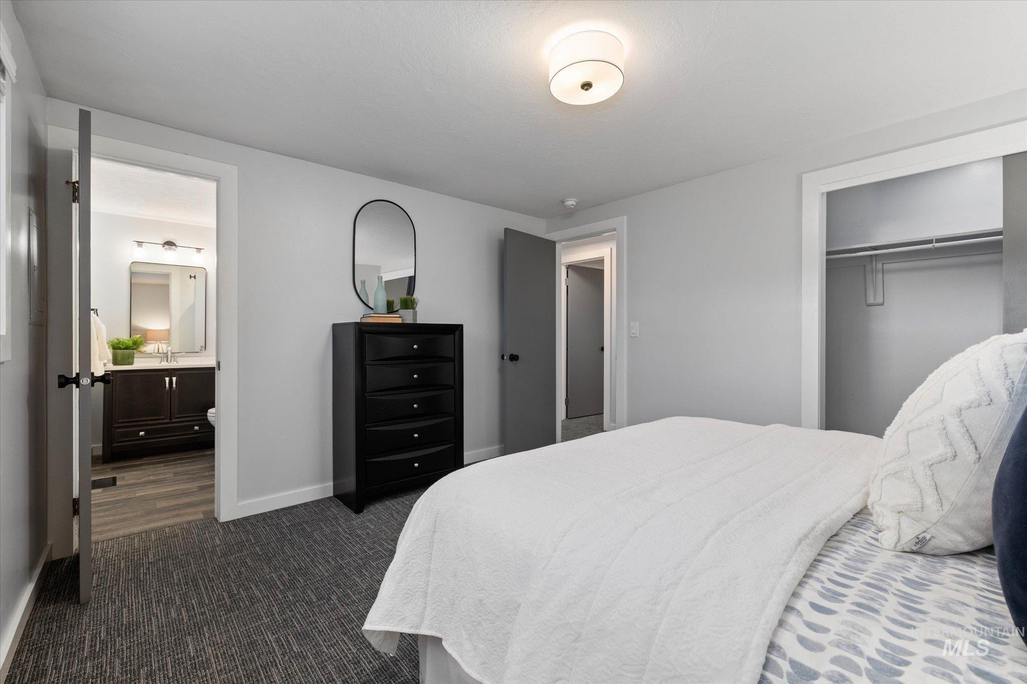 Bedroom featuring a closet and dark carpet