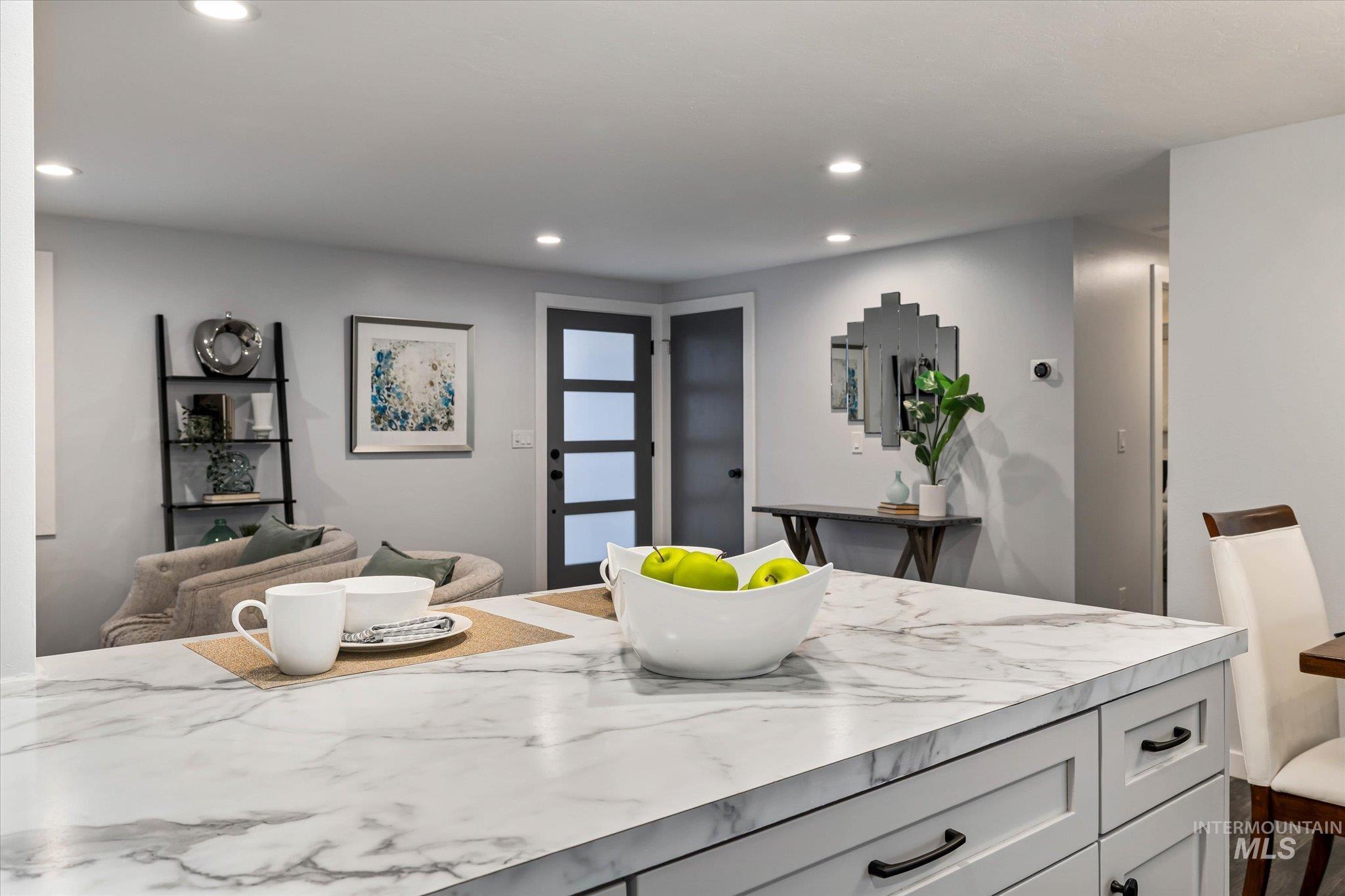Kitchen featuring light countertops, recessed lighting, and open floor plan