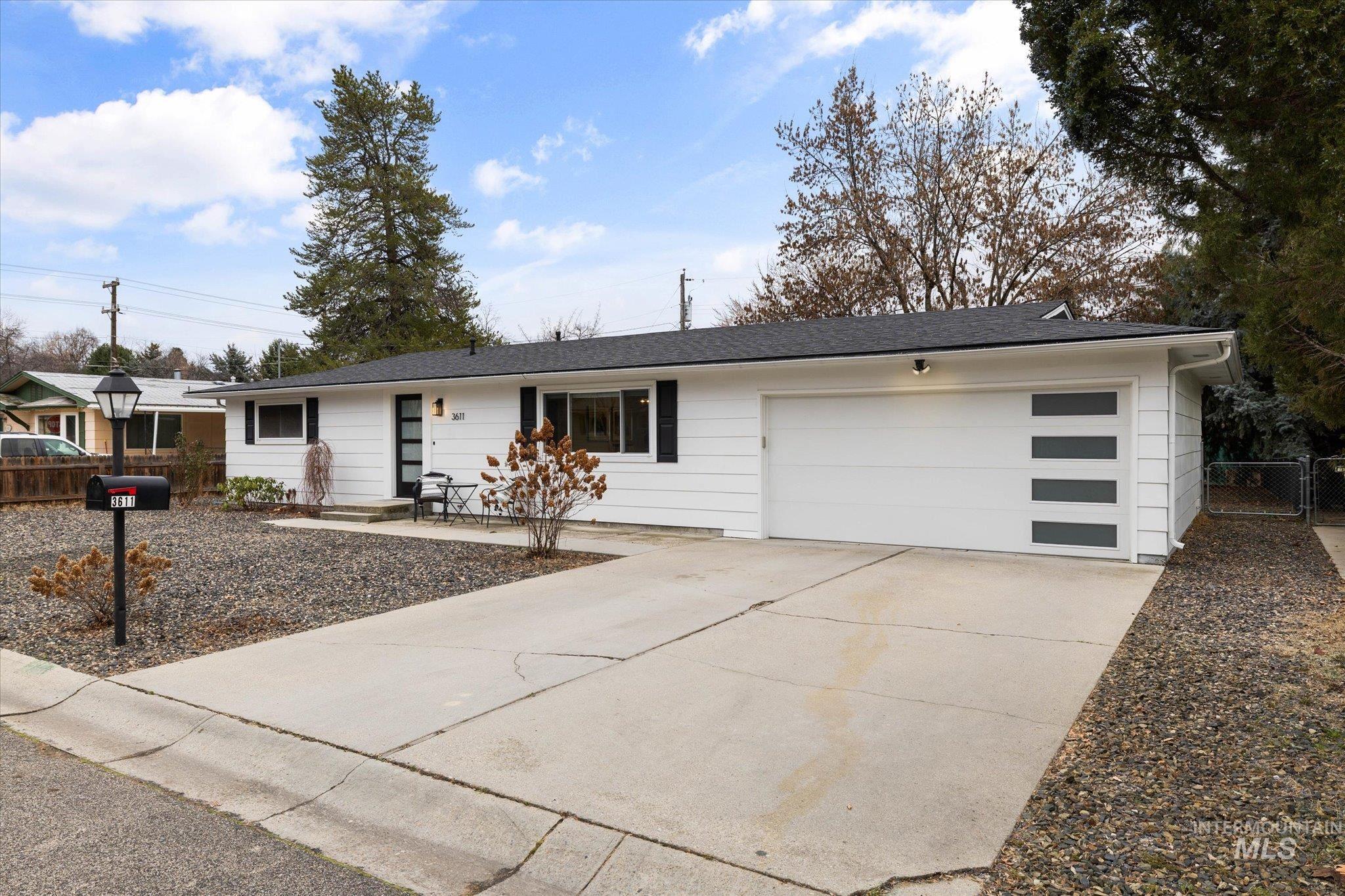 View of front of house with concrete driveway and a garage