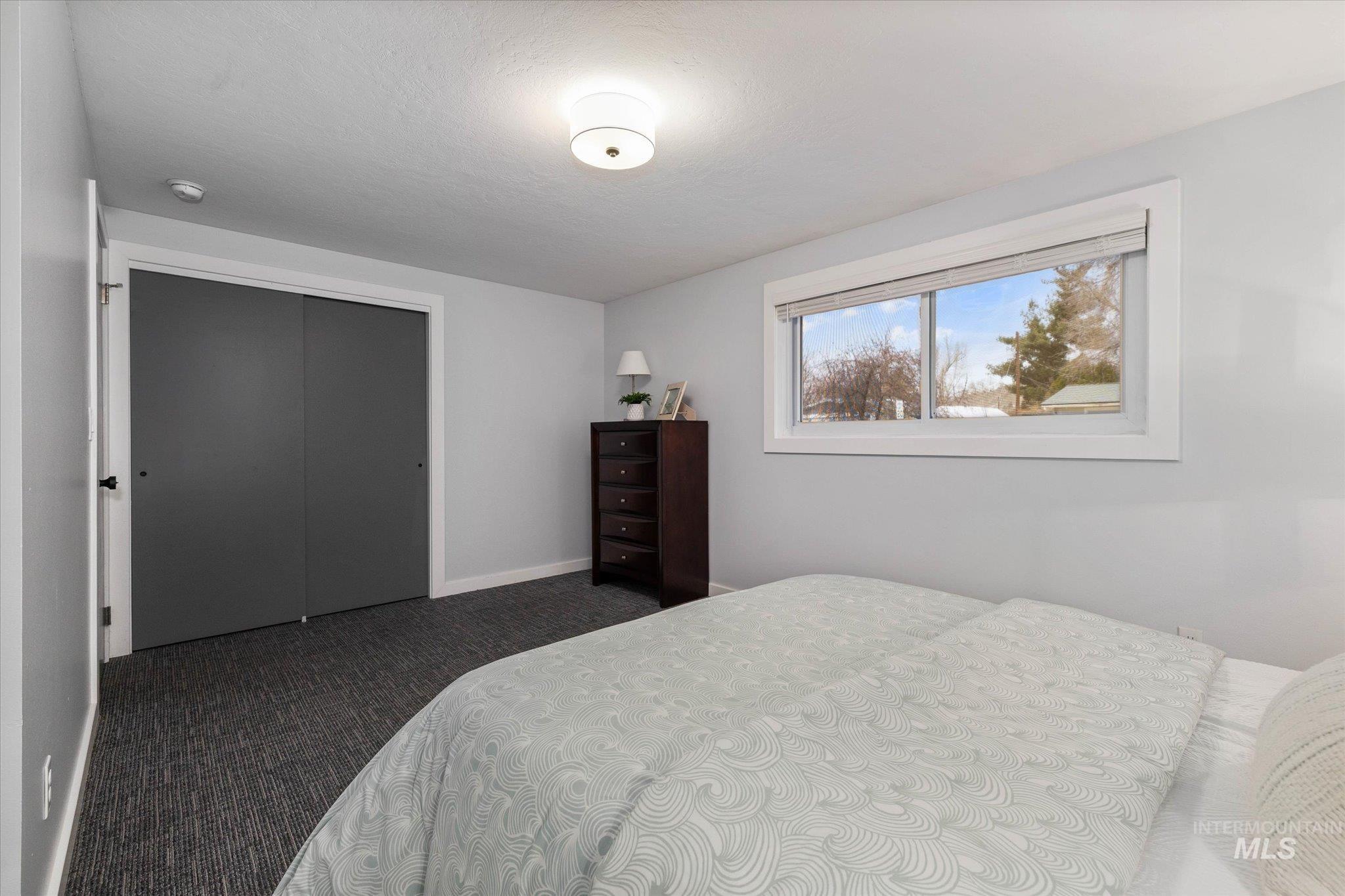 Bedroom featuring carpet flooring and a closet