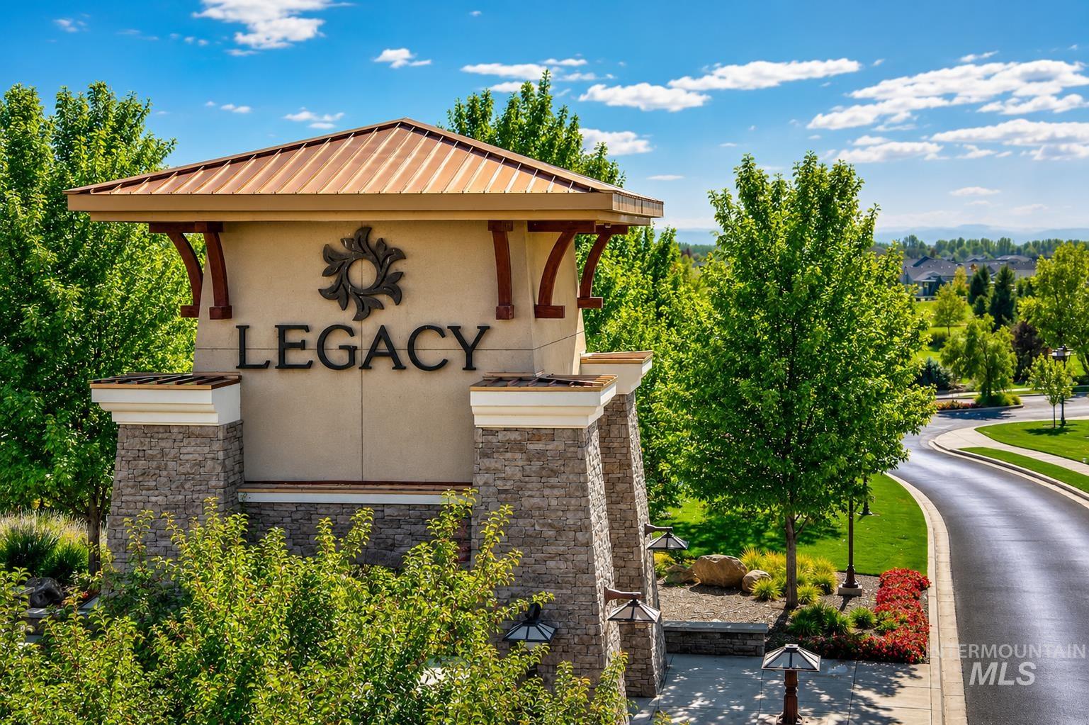 Legacy community entrance monument featuring stone columns and a metal roof