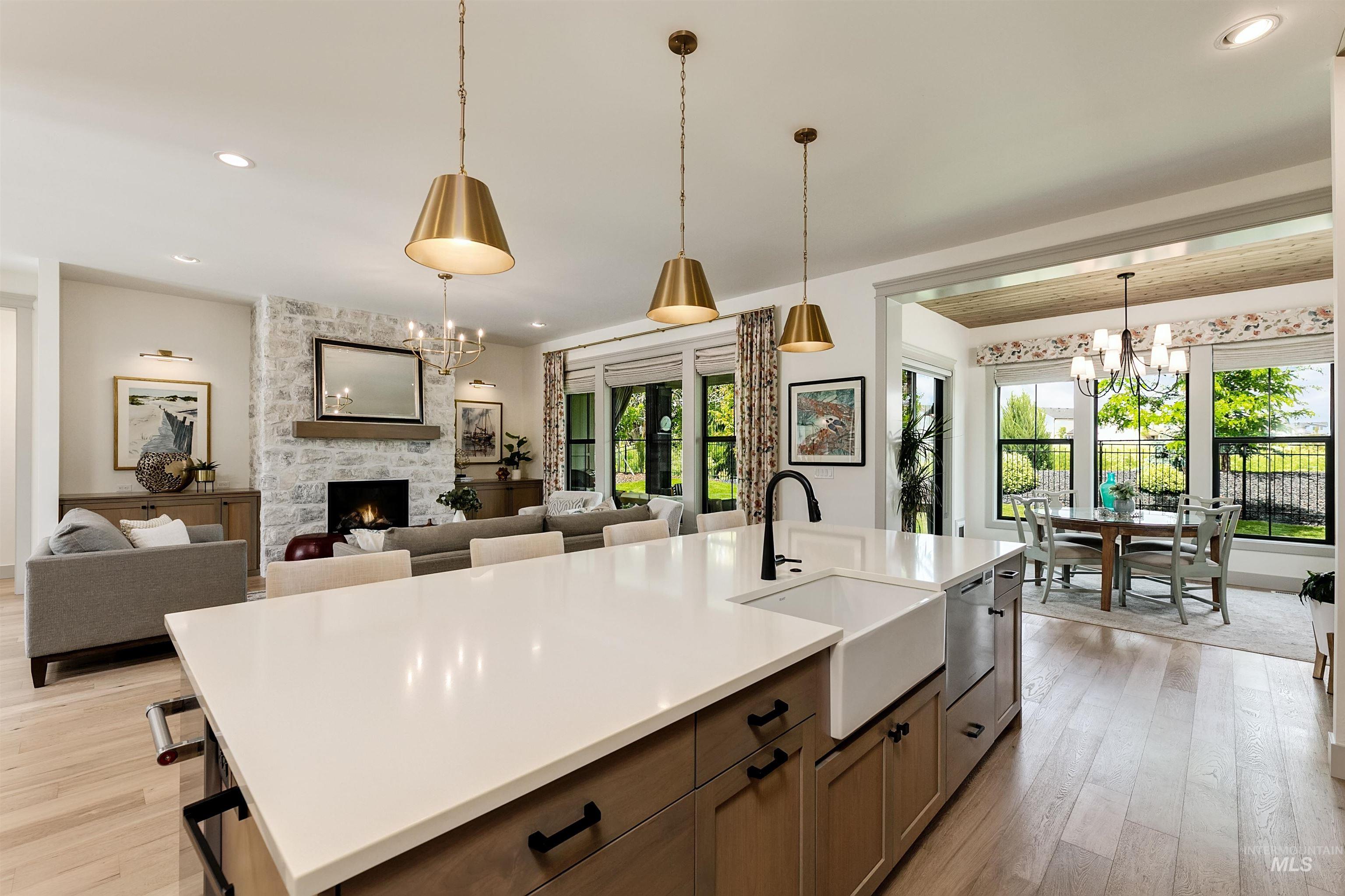 Kitchen island with white countertop, farmhouse sink, and matte black faucet
