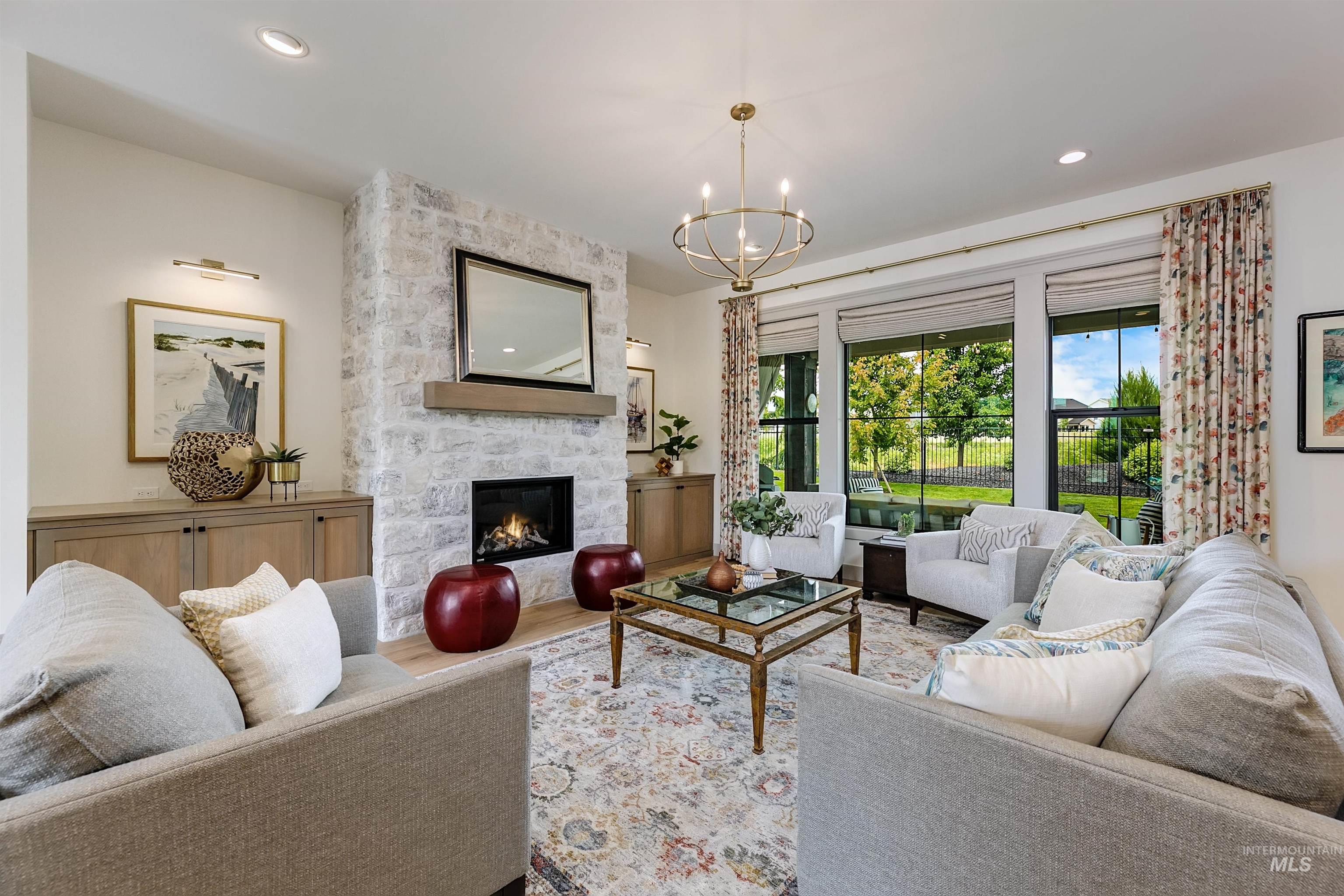 Living area featuring a stone-clad fireplace with a wood mantel, a built-in linear fireplace, and recessed lighting