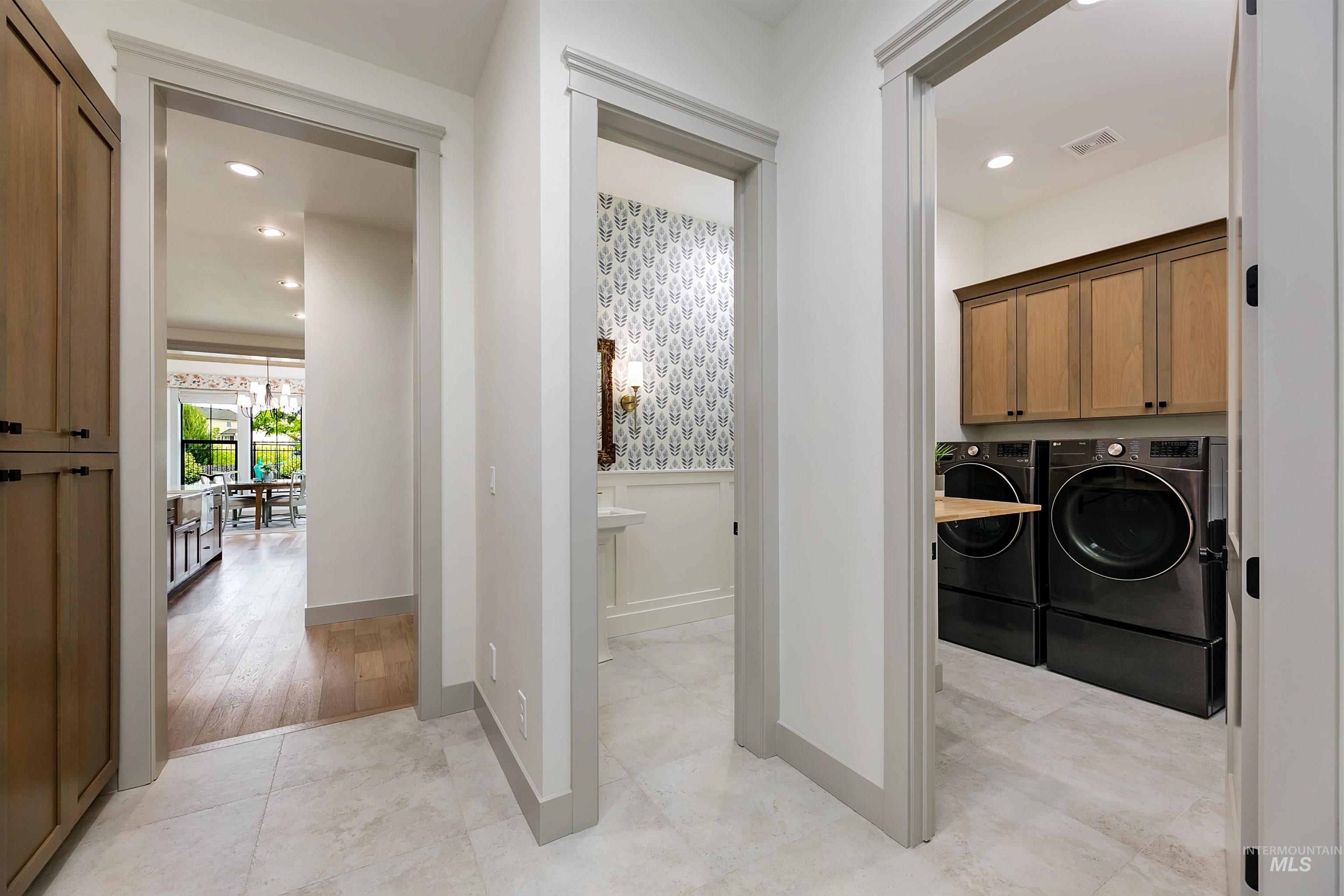 Hallway featuring light tile flooring and recessed lighting