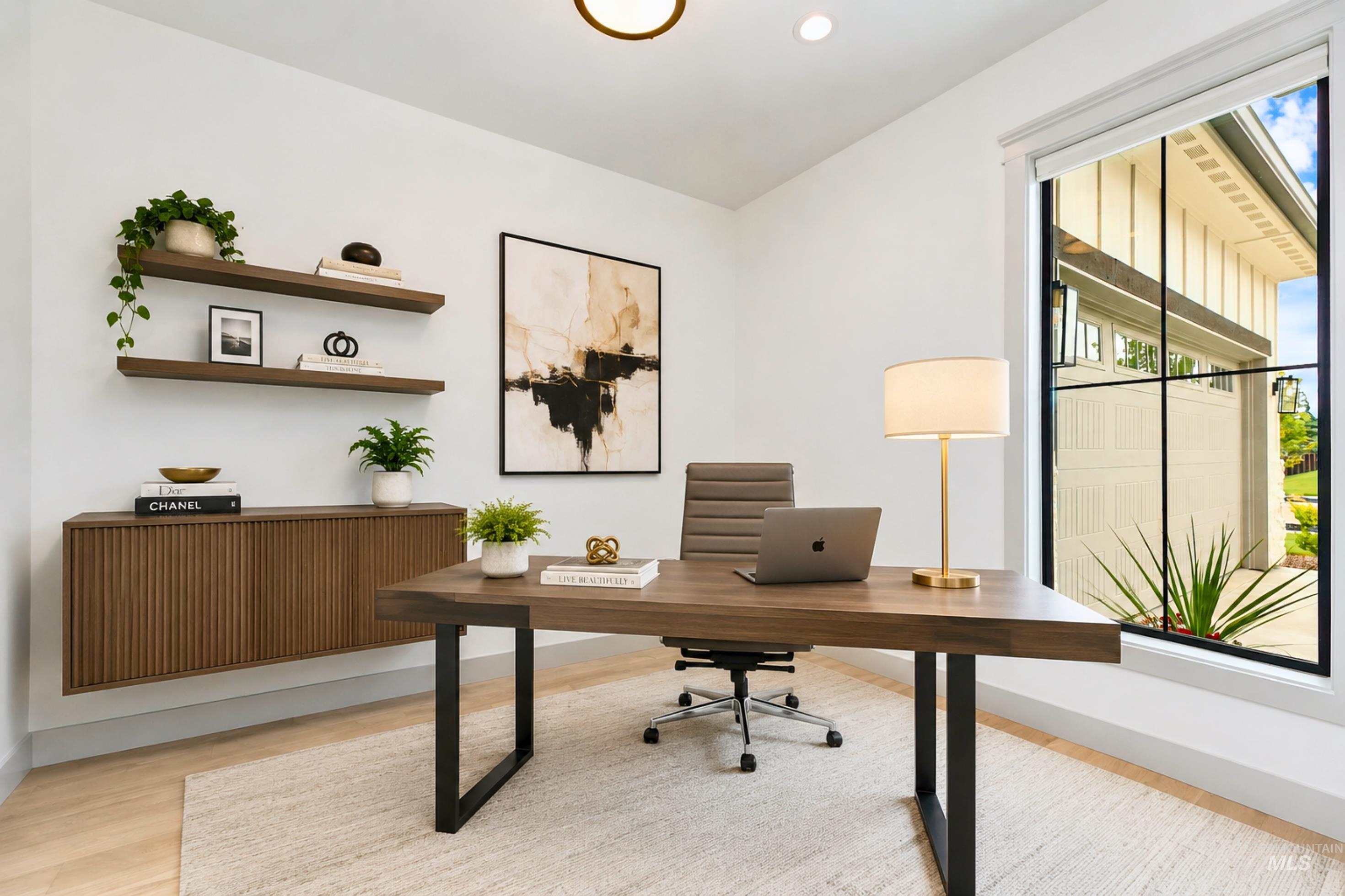Dedicated workspace featuring light wood-finish flooring and white walls