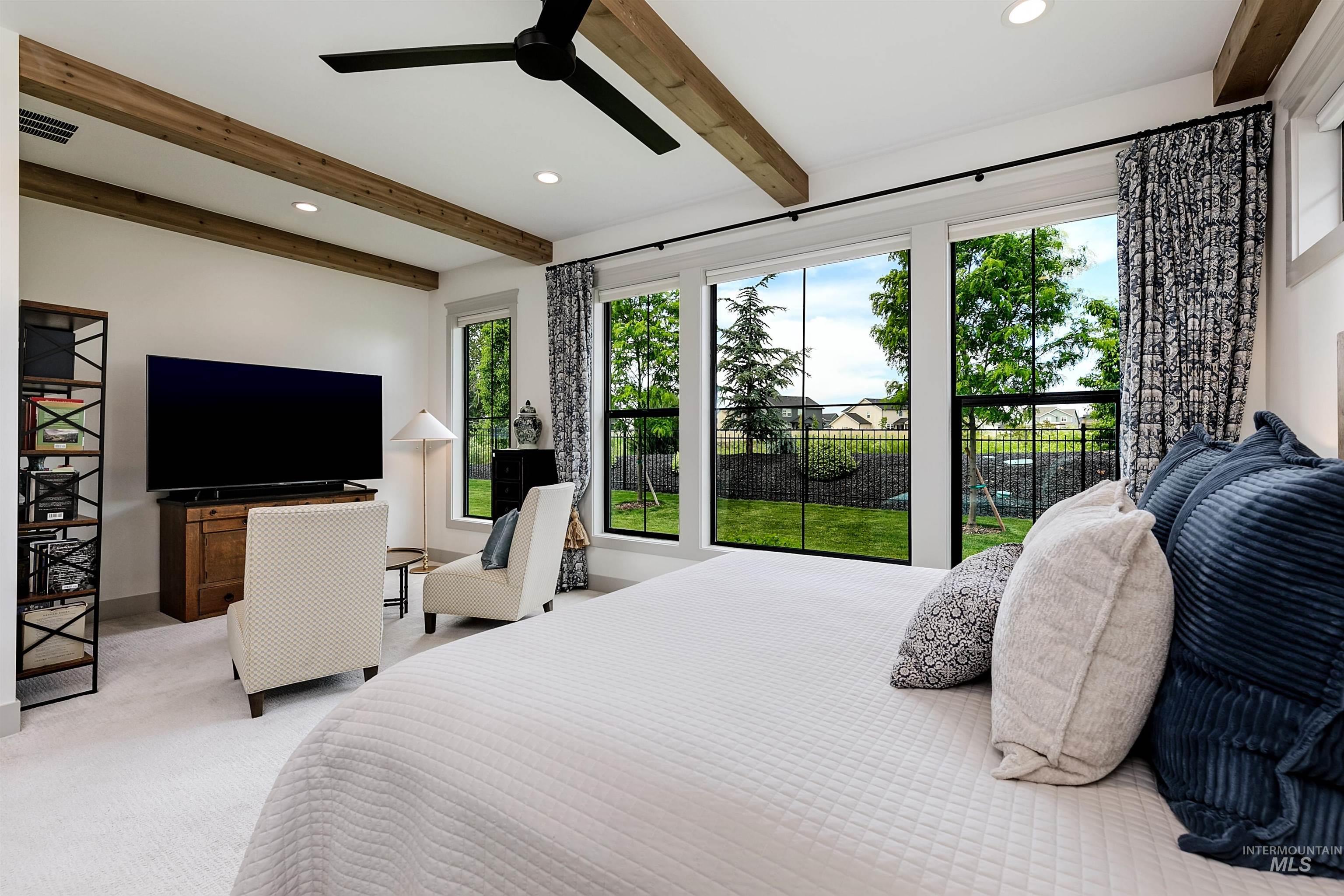 Room featuring a wall of expansive windows overlooking a fenced rear yard, white ceiling with exposed wood beams, ceiling fan, and recessed lighting