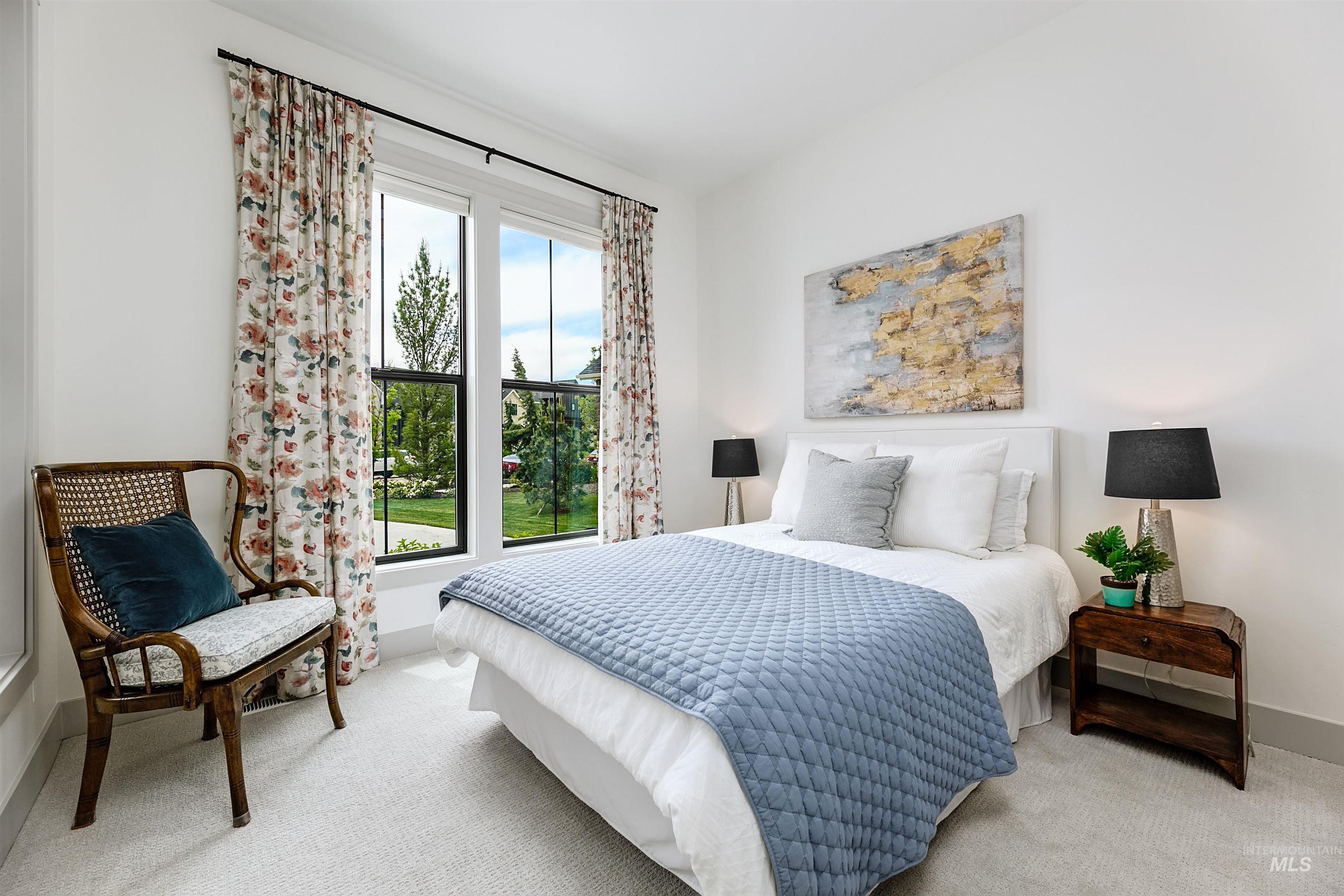 Bedroom featuring a large window, plush carpeting, white walls, and a recessed ceiling