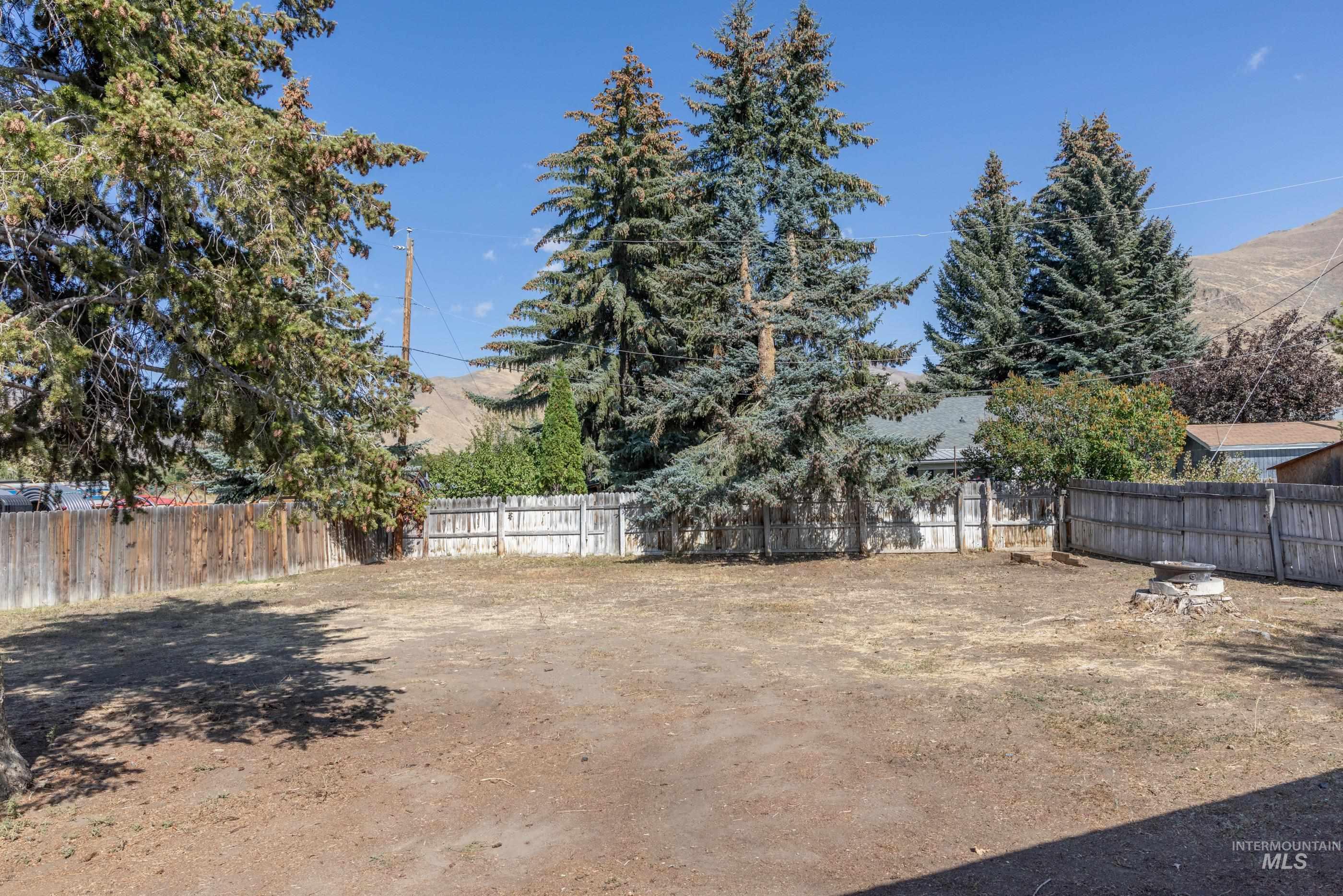 Fenced backyard with a mountain view