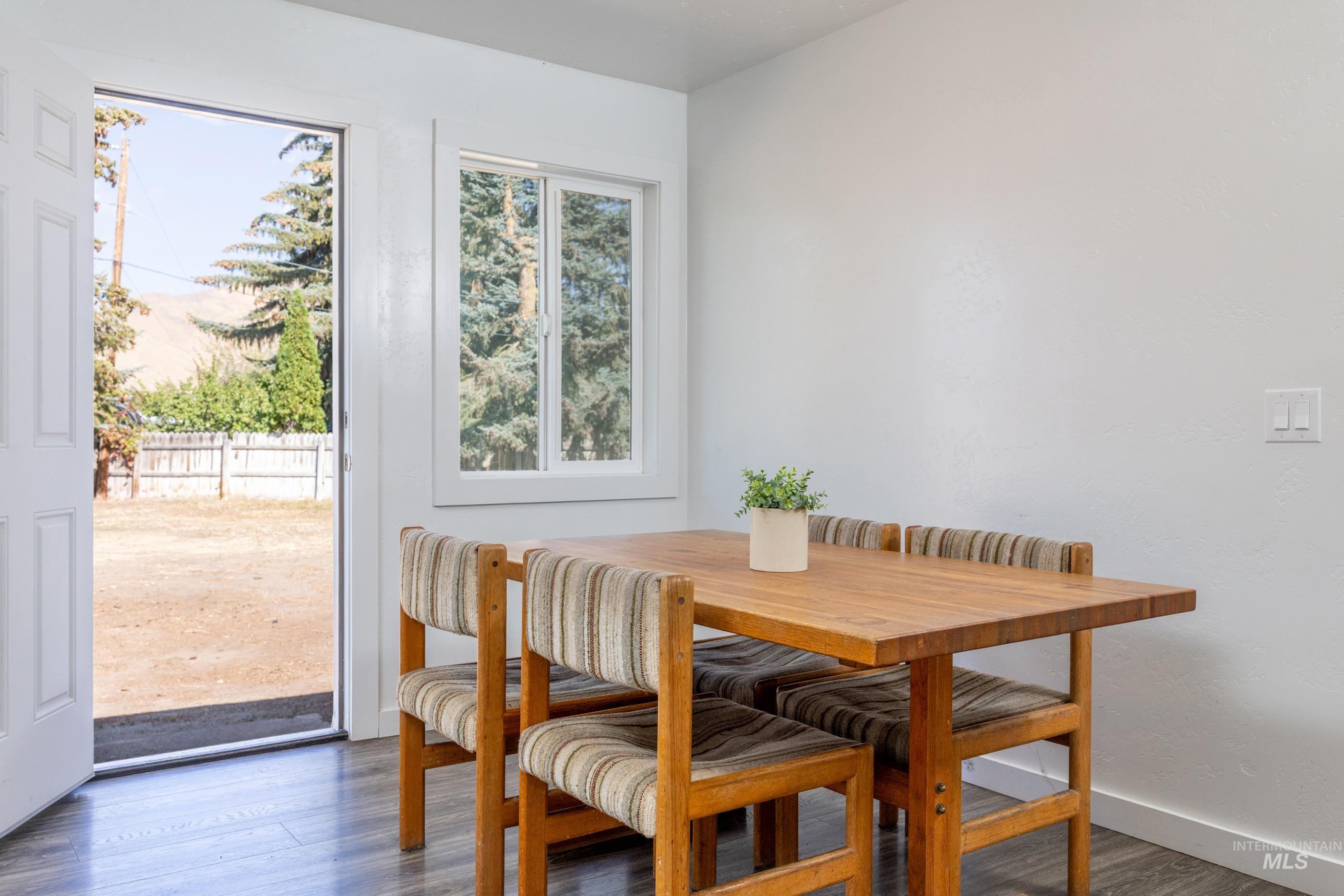 Dining room with wood finished floors and baseboards