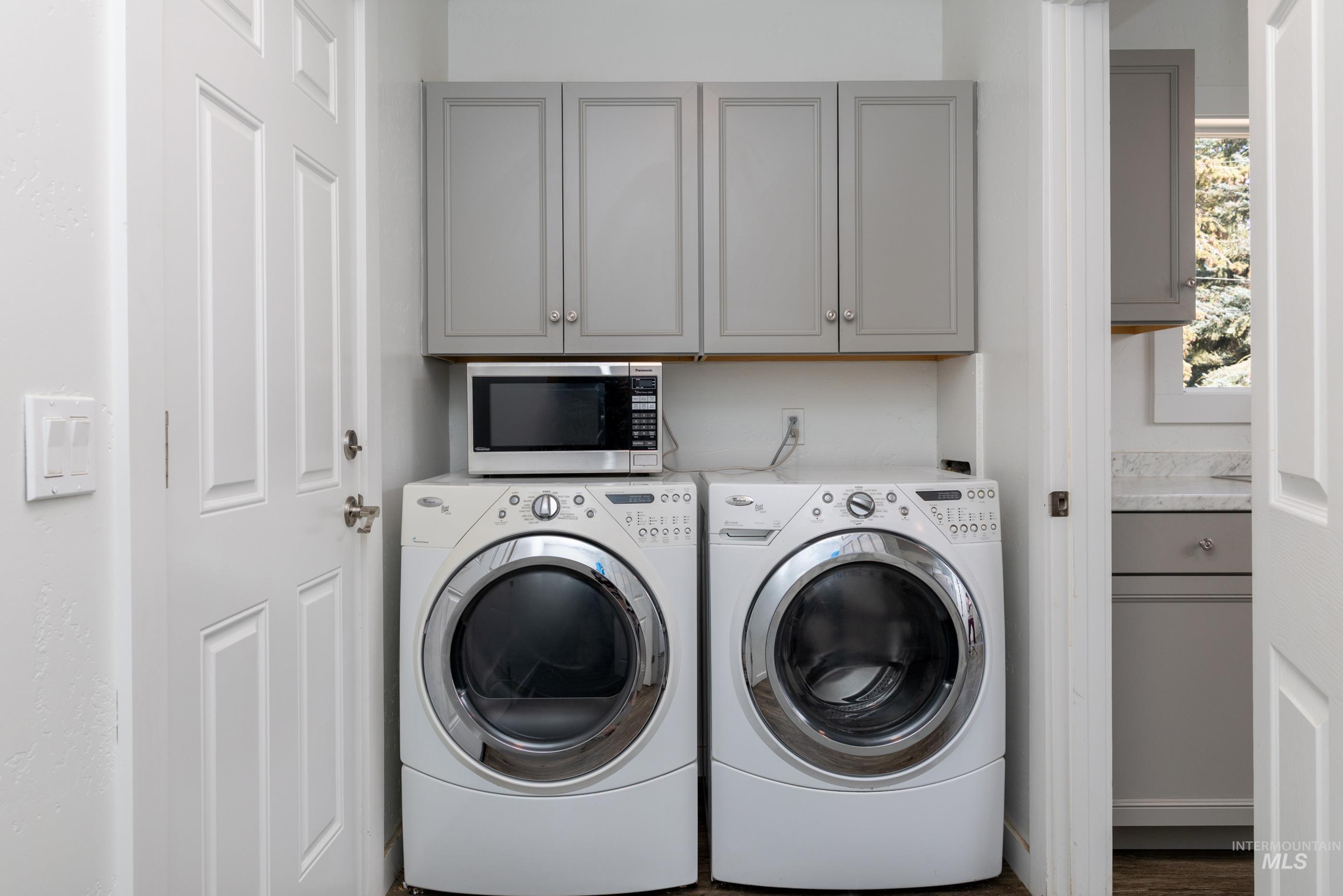 Laundry area featuring cabinet space and independent washer and dryer