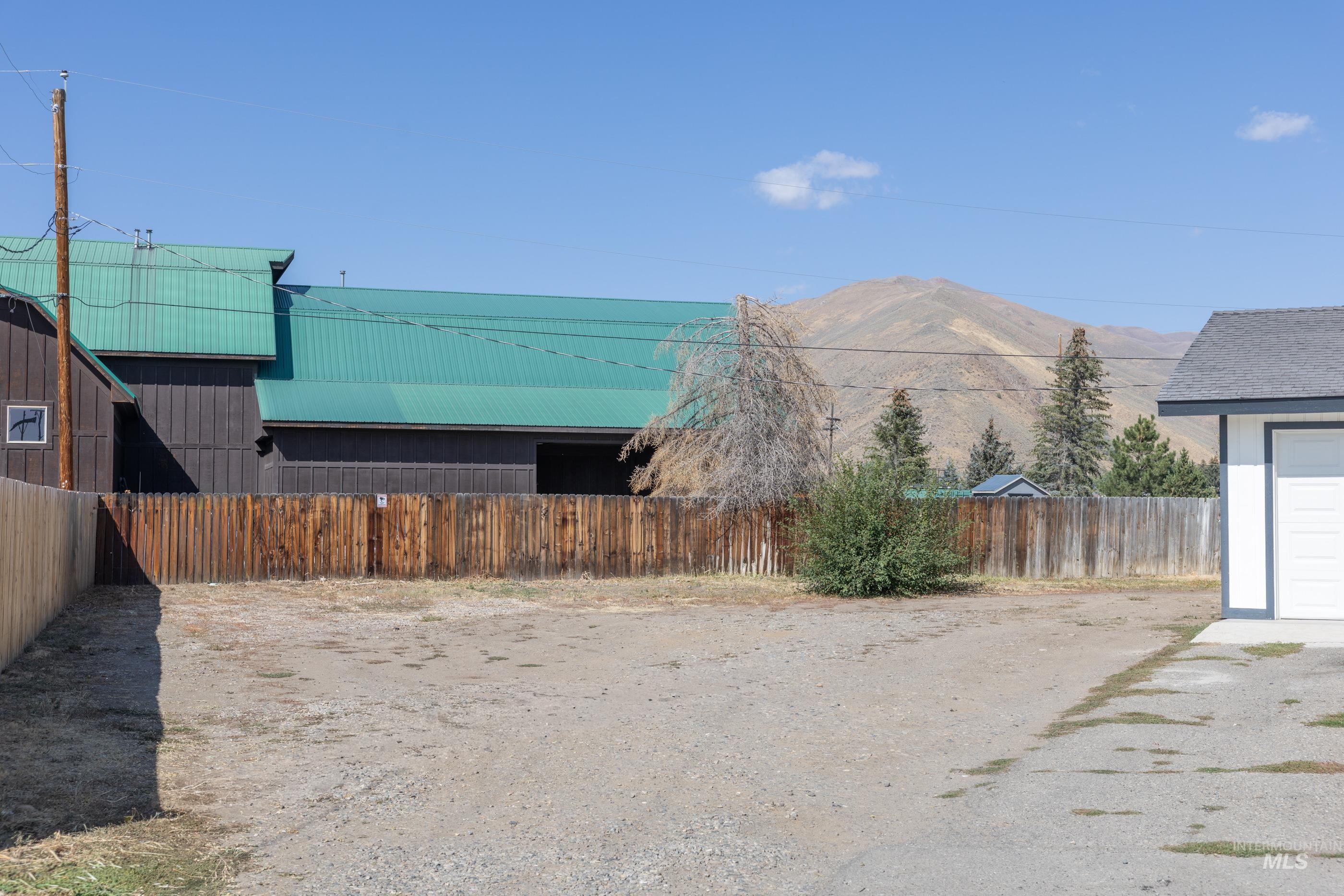 Fenced backyard featuring a mountain view