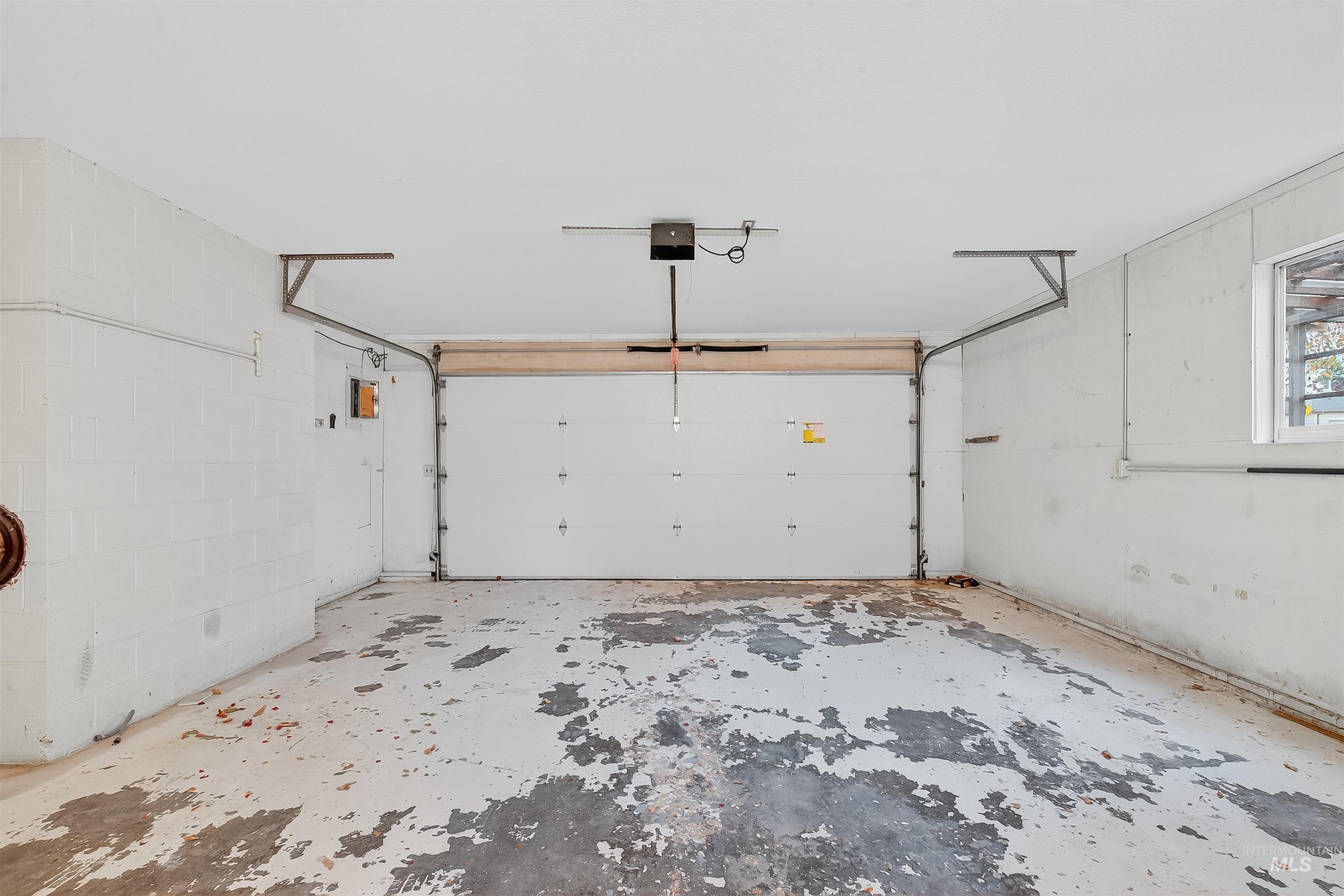 Garage featuring a garage door opener