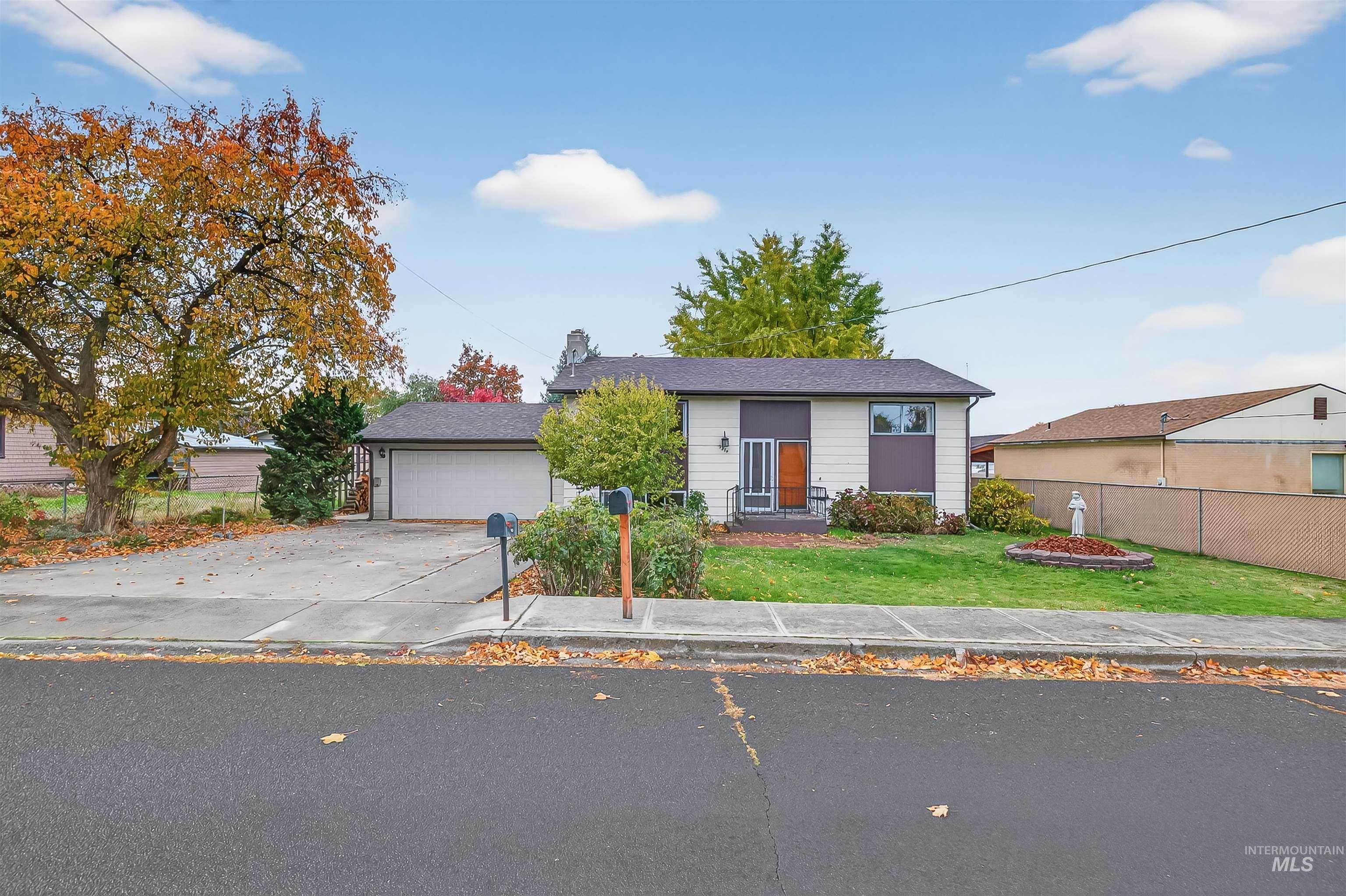 Bungalow-style house featuring driveway and a garage