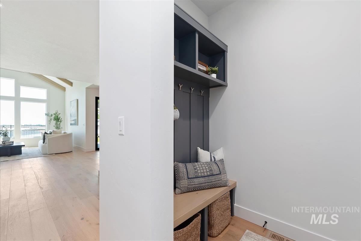 Mudroom with light wood finished floors and baseboards