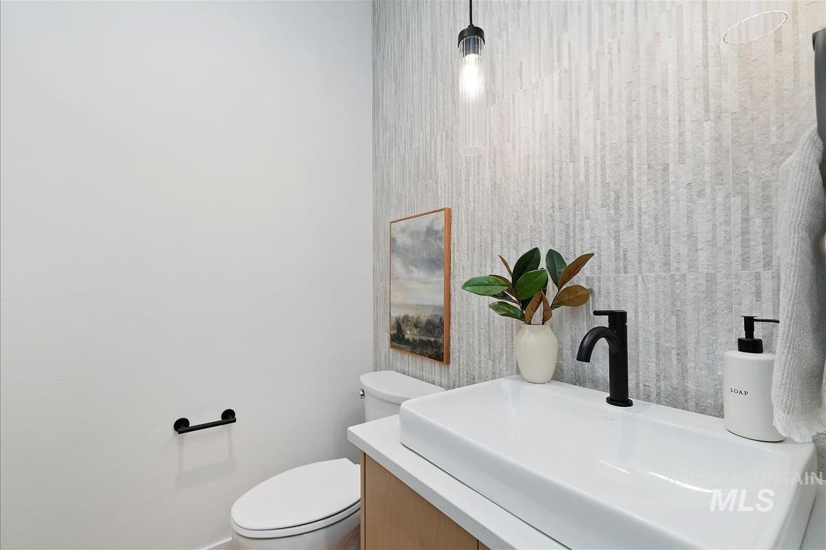 Half bathroom with toilet and vanity