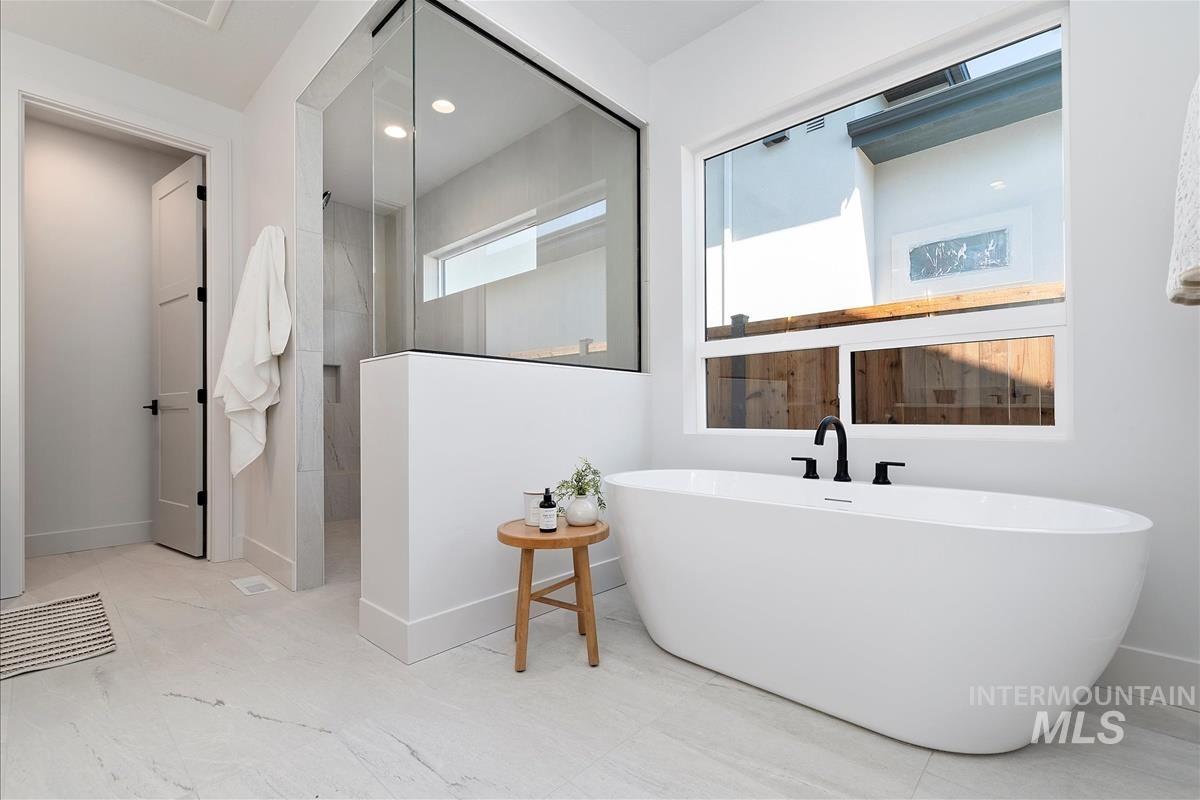 Bathroom with a soaking tub and a walk in shower