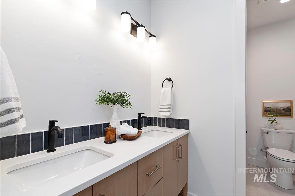 Bathroom with double vanity and tile patterned floors