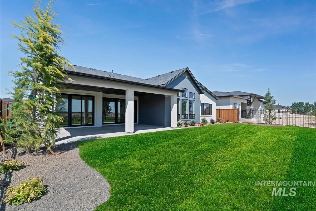Rear view of house featuring a patio and stucco siding