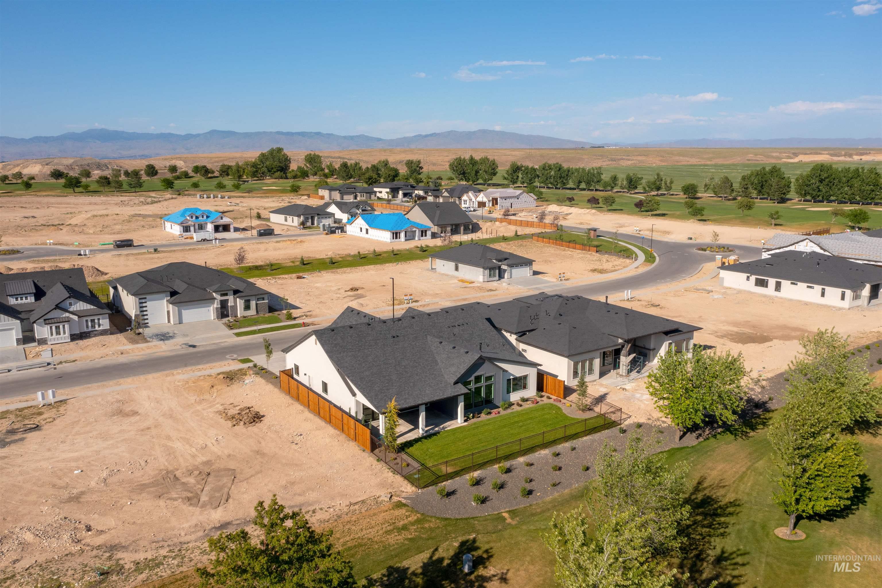 Aerial perspective of suburban area featuring a mountain backdrop