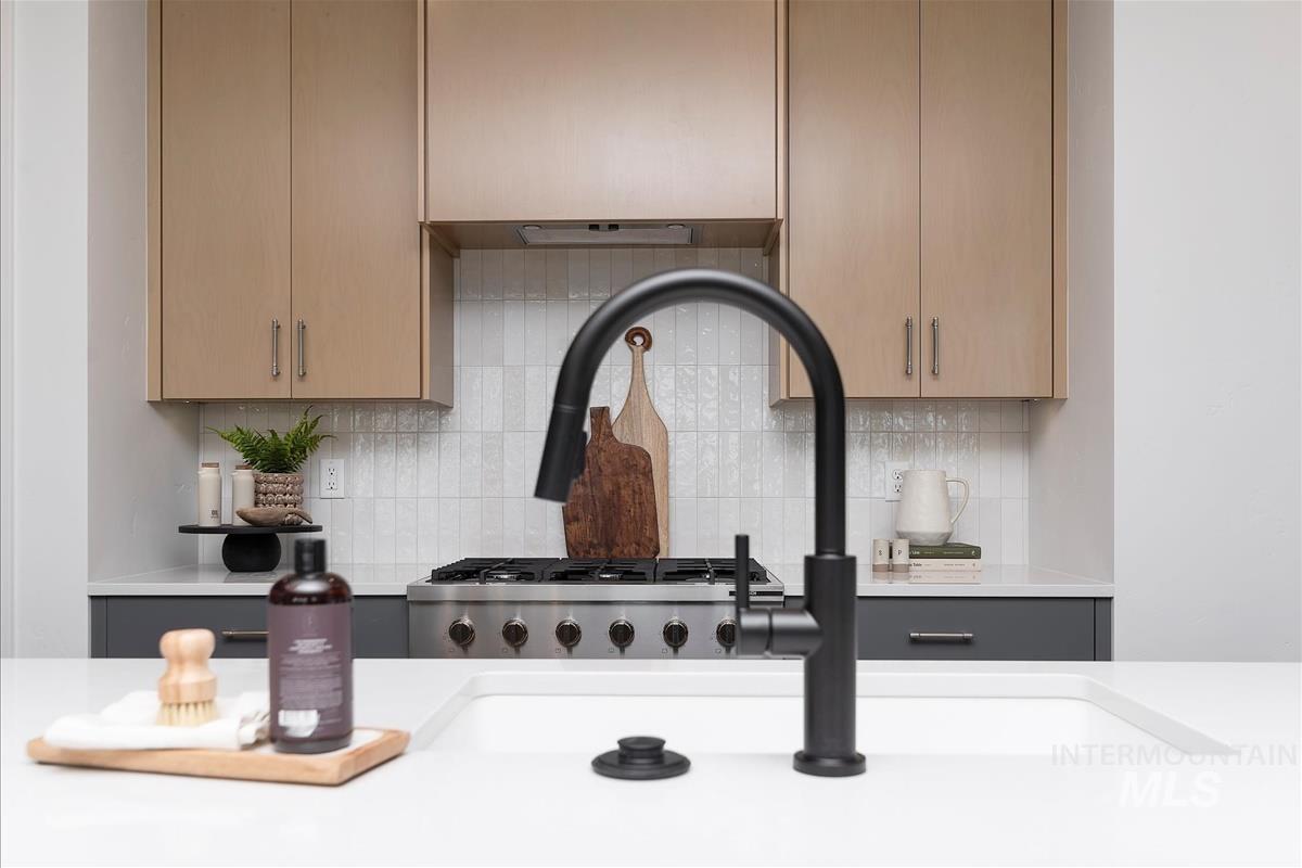 Kitchen with light countertops and backsplash