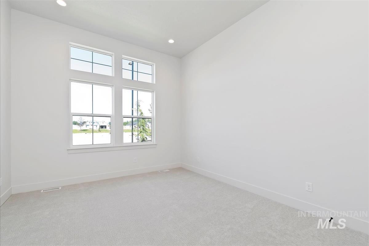 Spare room with light colored carpet and recessed lighting