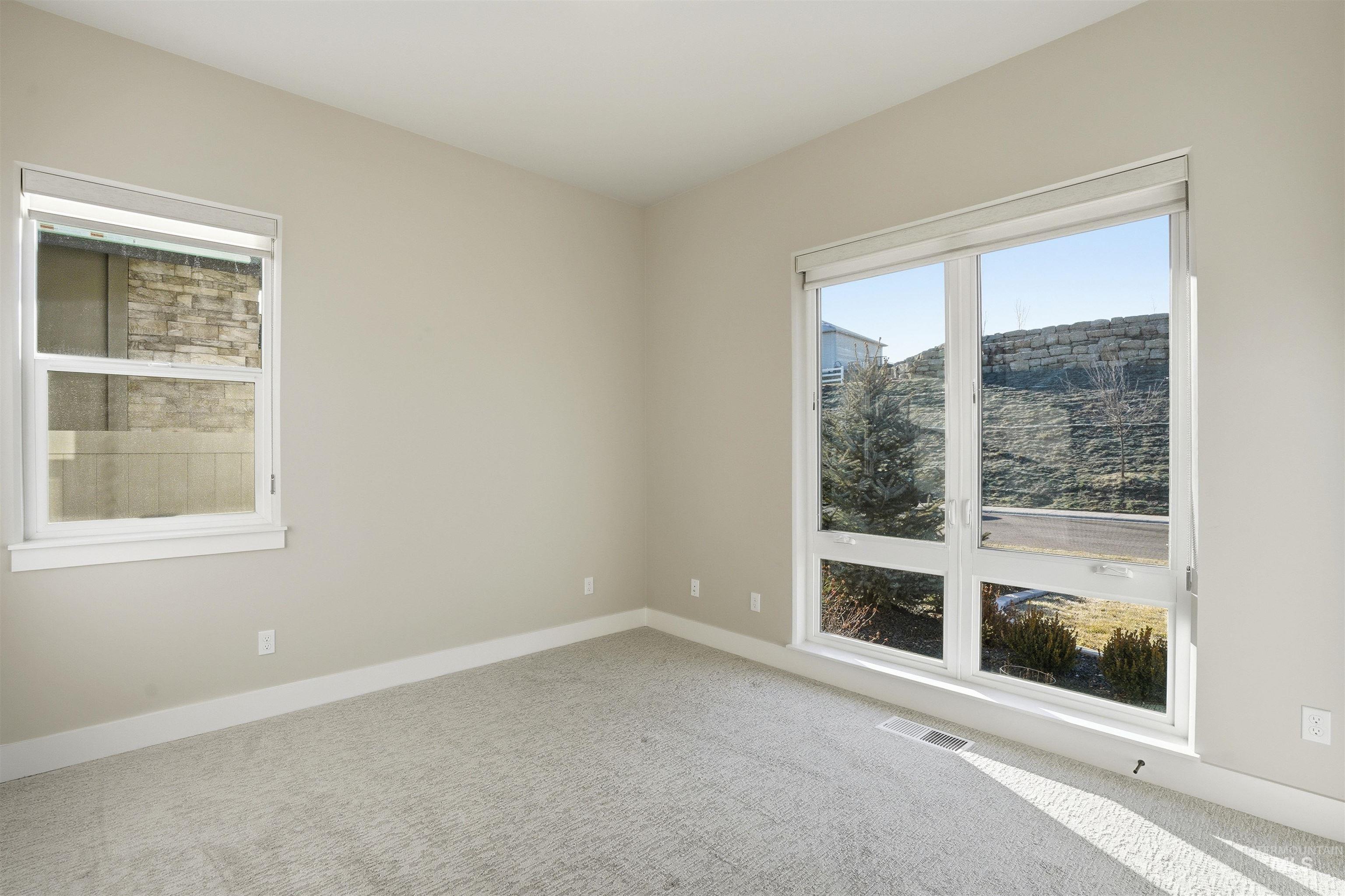 Carpeted spare room with baseboards