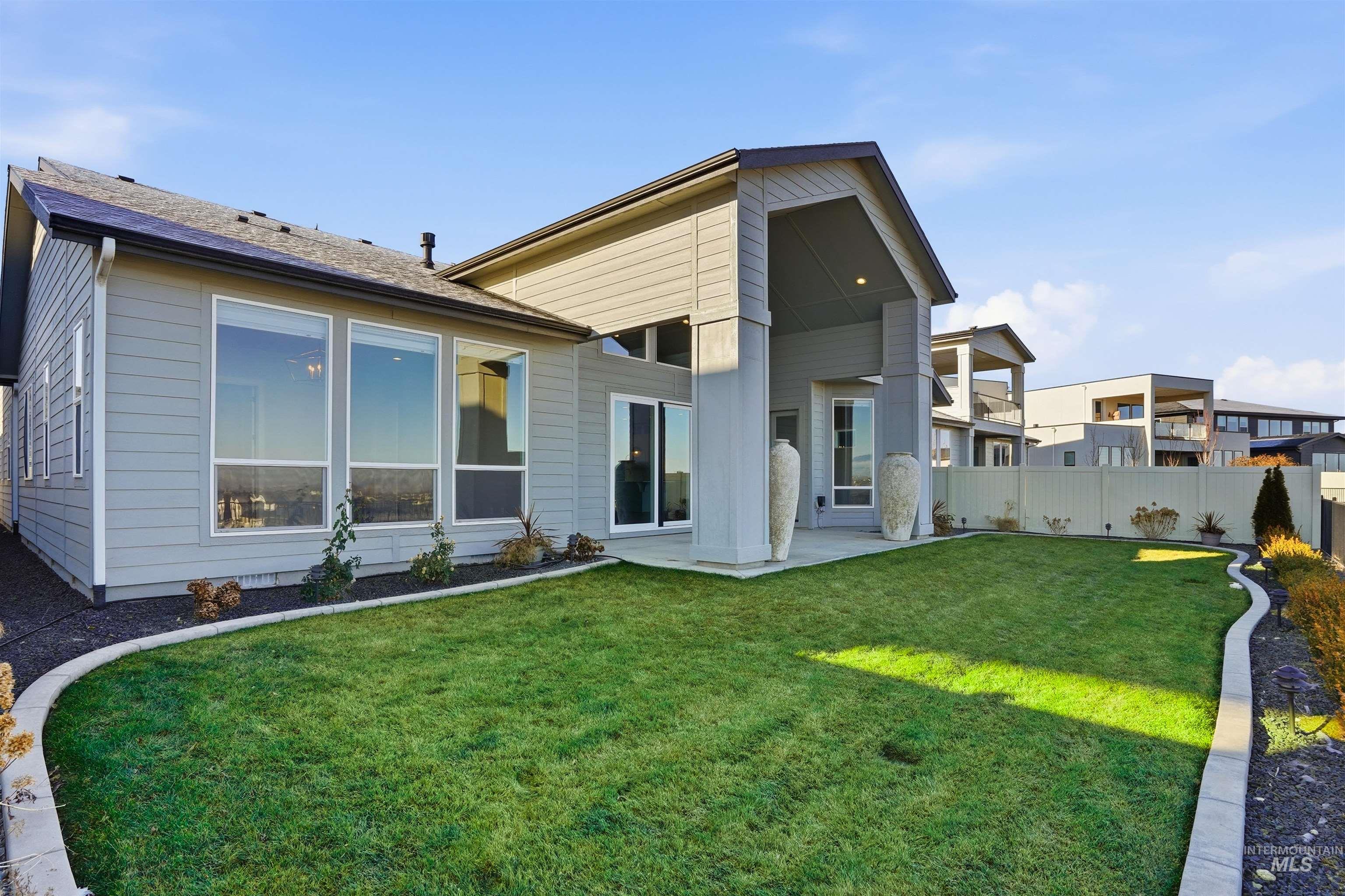 Rear view of house featuring a fenced backyard and a patio
