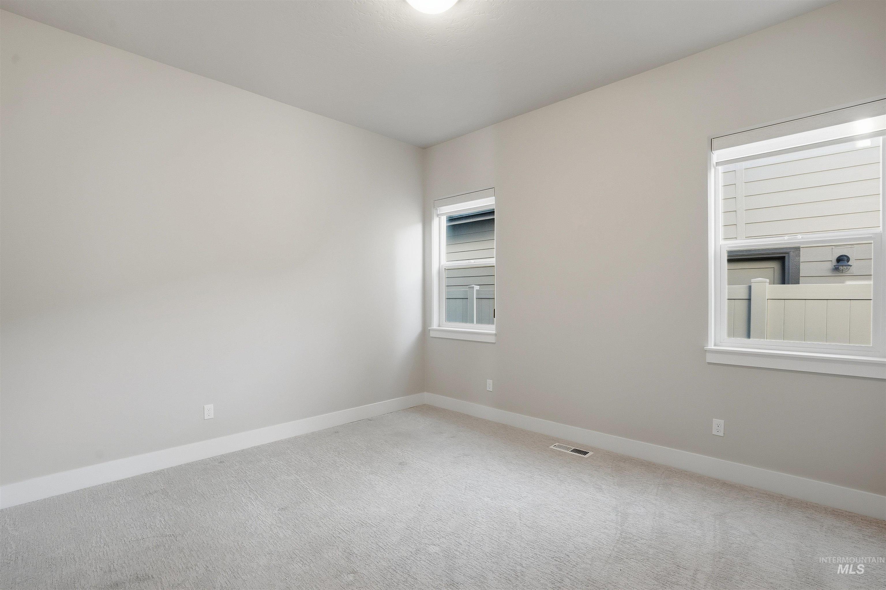 Empty room featuring baseboards and carpet