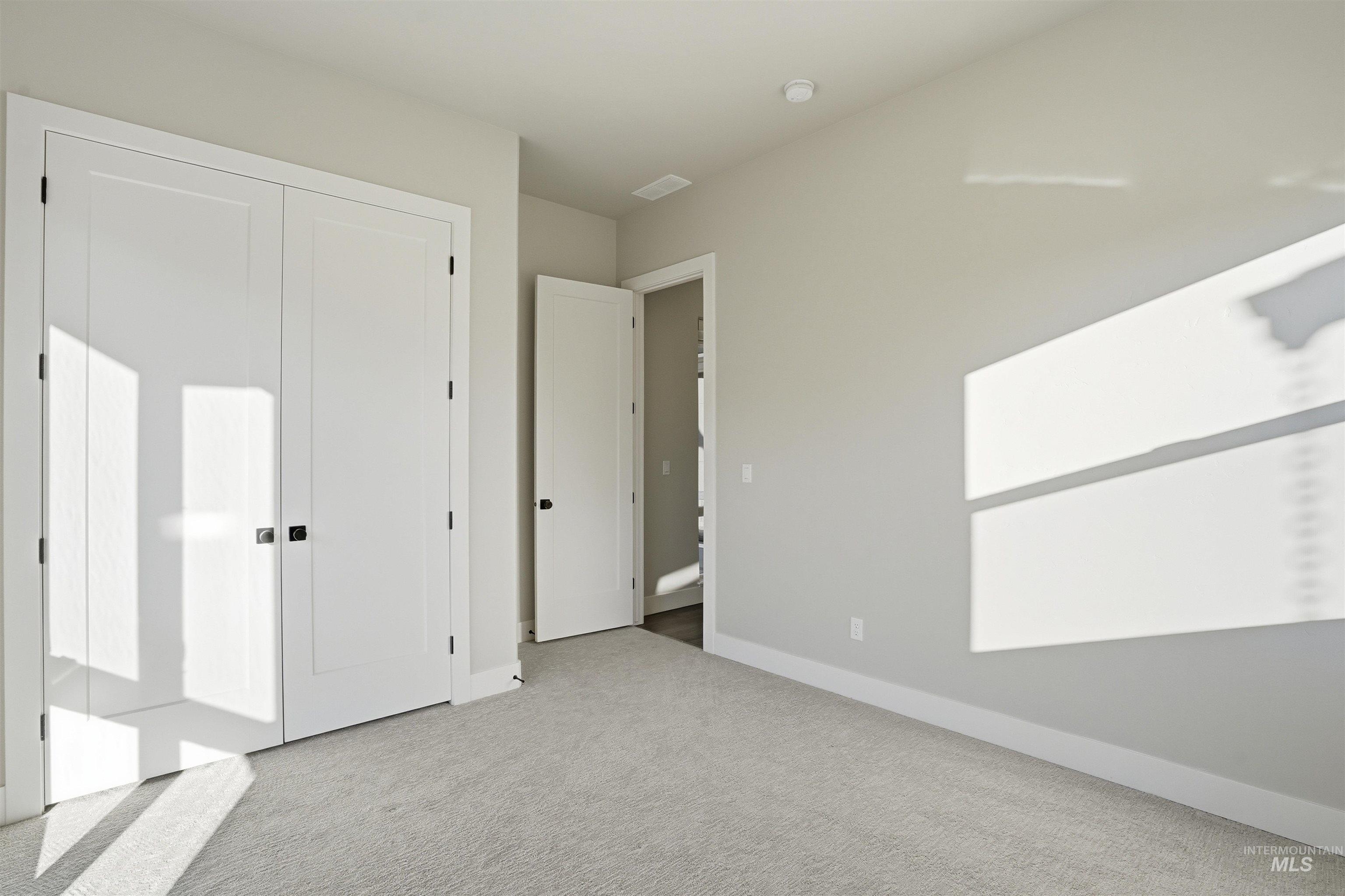 Unfurnished bedroom with carpet flooring and a closet