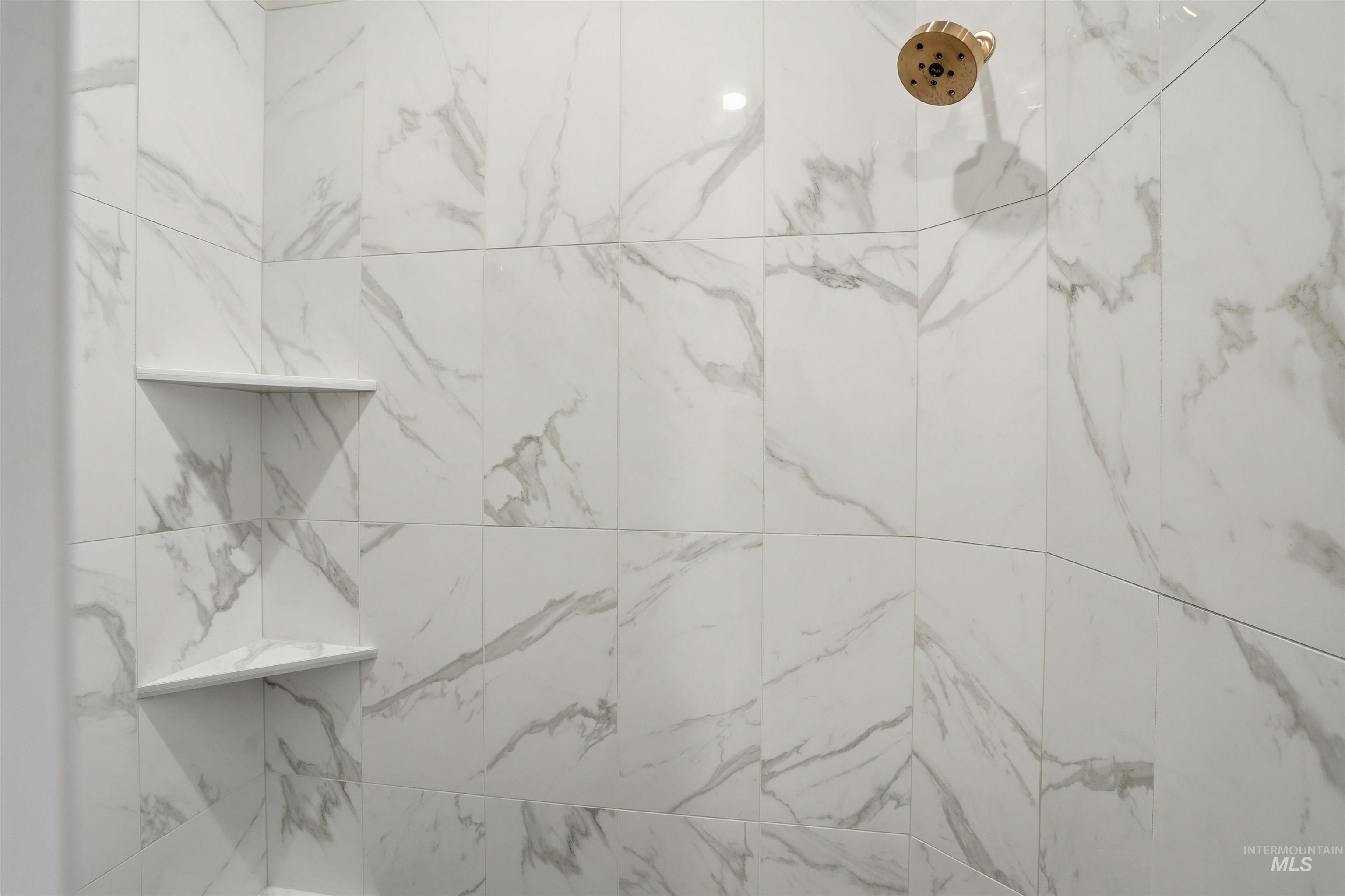 Bathroom view of a marble finish shower