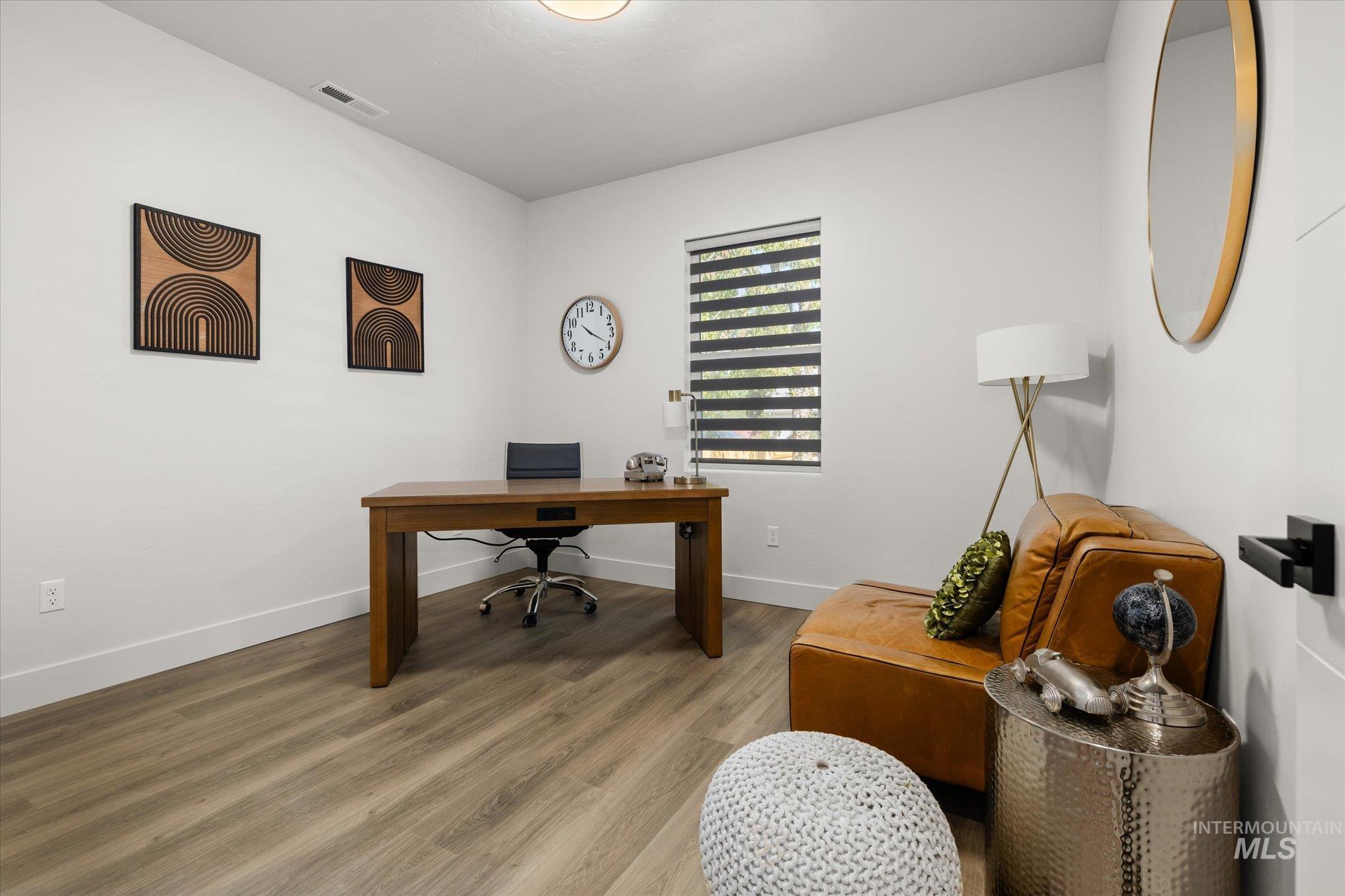 Office featuring wood finished floors and baseboards