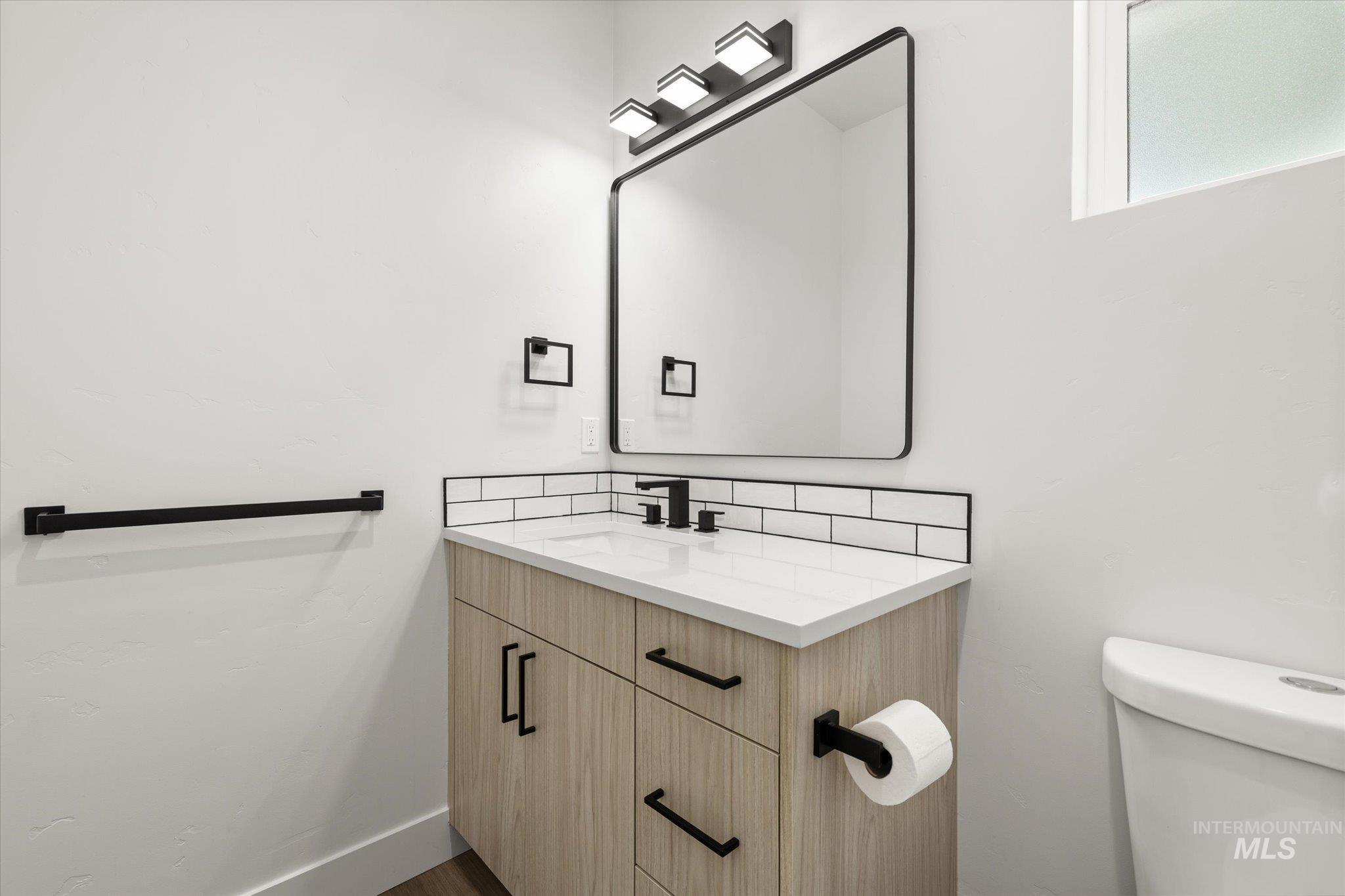 Bathroom featuring vanity and toilet