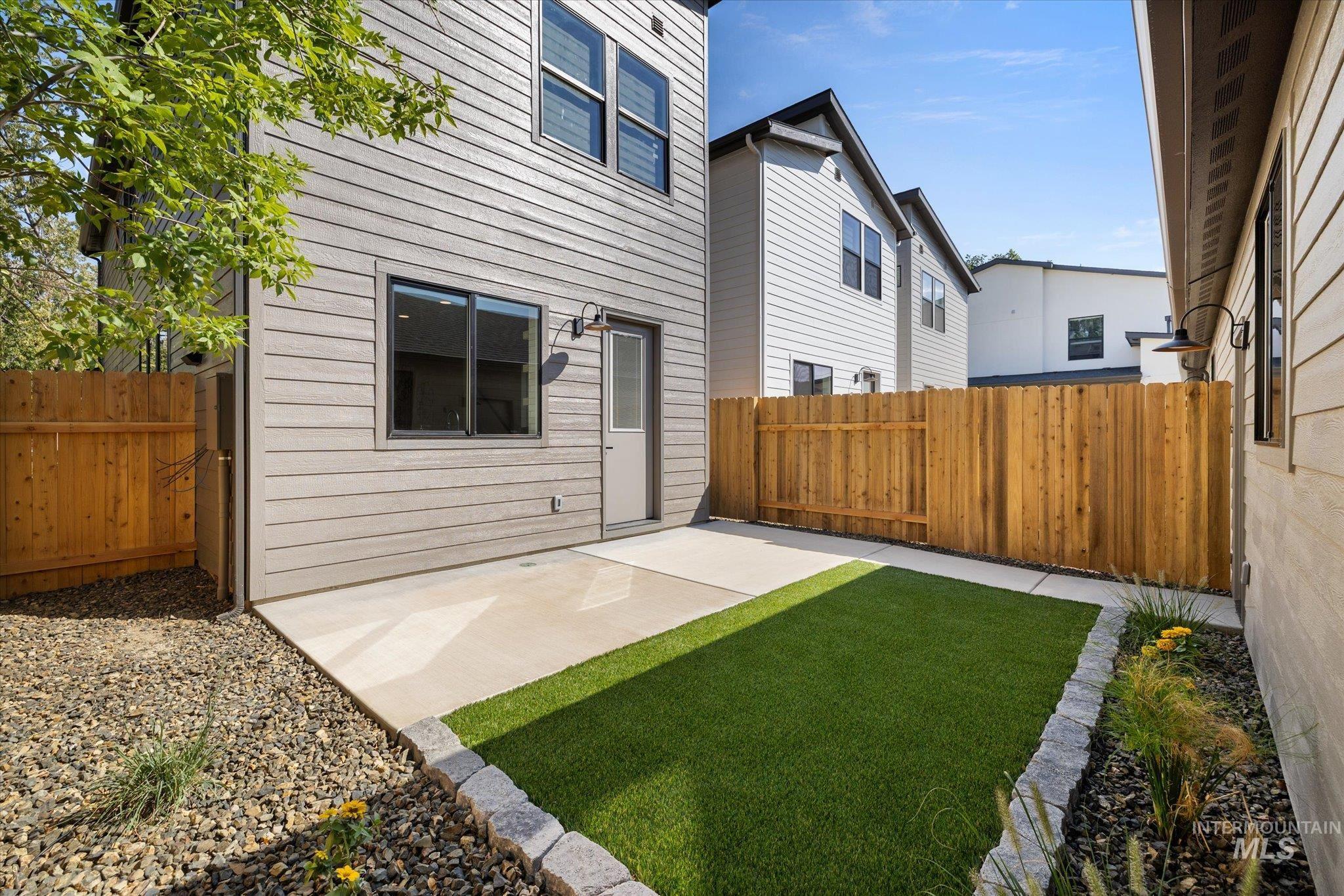 Back of property with a fenced backyard and a patio area