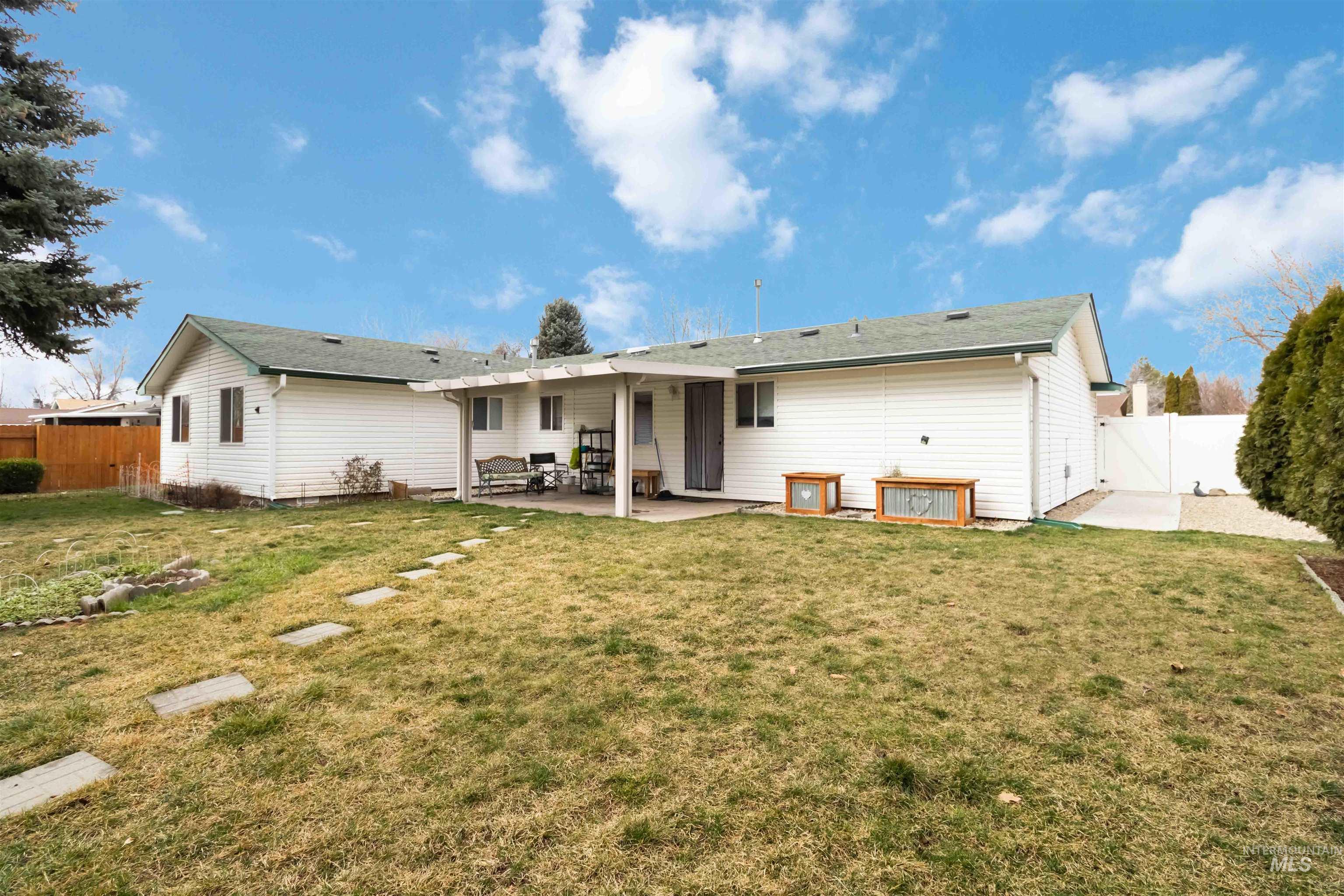 Back of house featuring a patio, a fenced backyard, and a gate