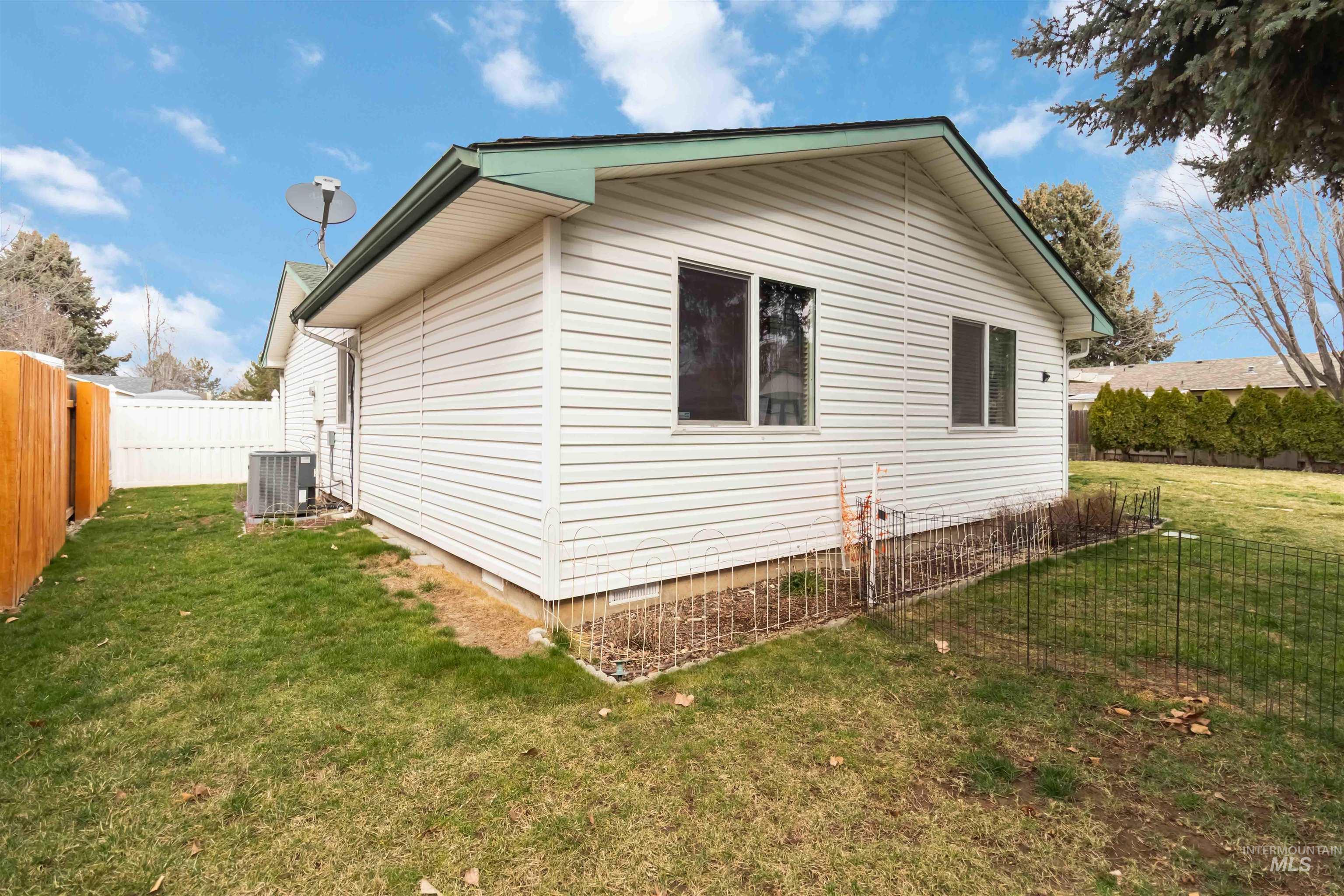 View of side of home featuring crawl space and a fenced backyard