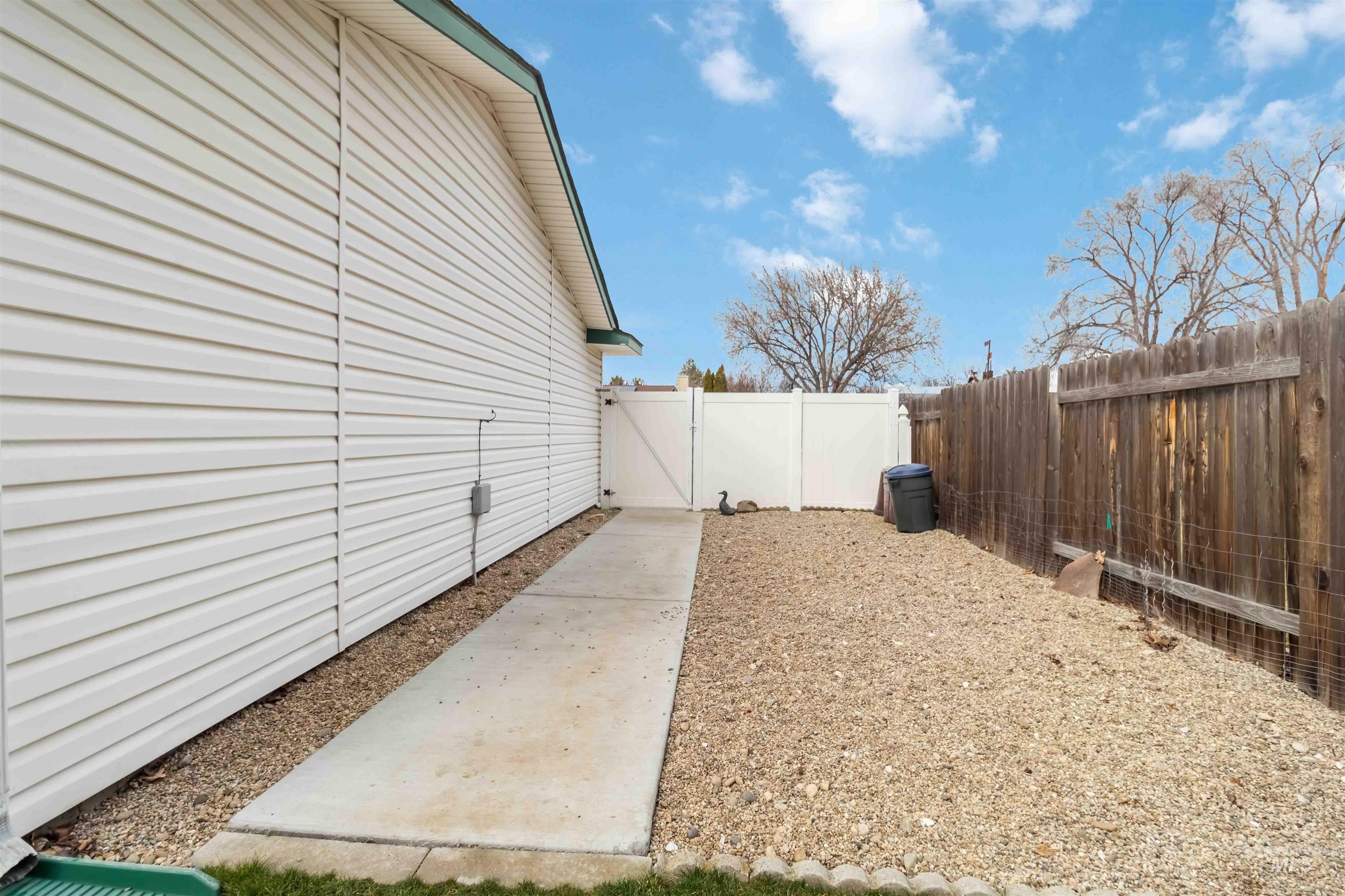 Fenced backyard featuring a gate