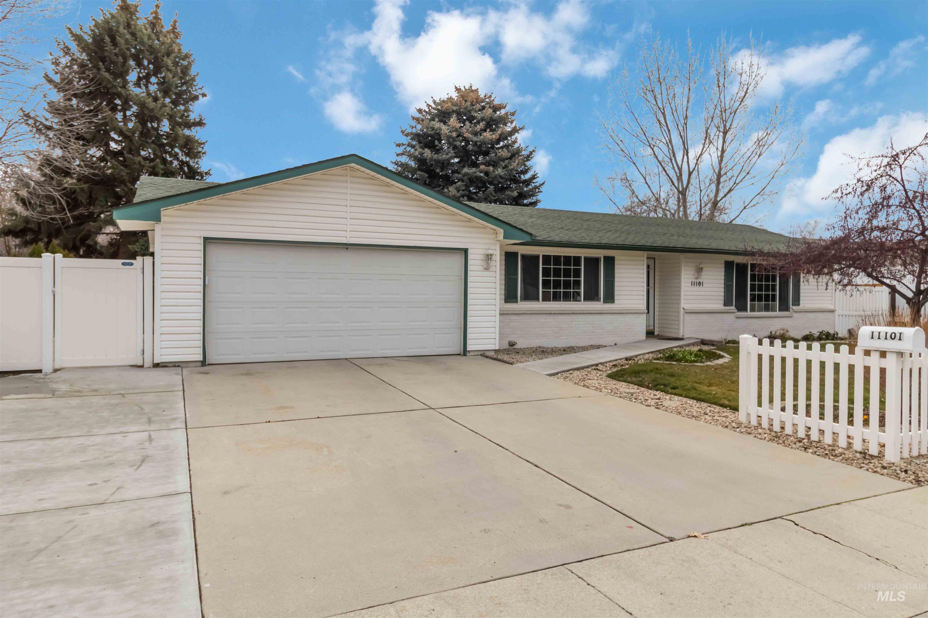 Ranch-style home featuring concrete driveway, a garage, and brick siding