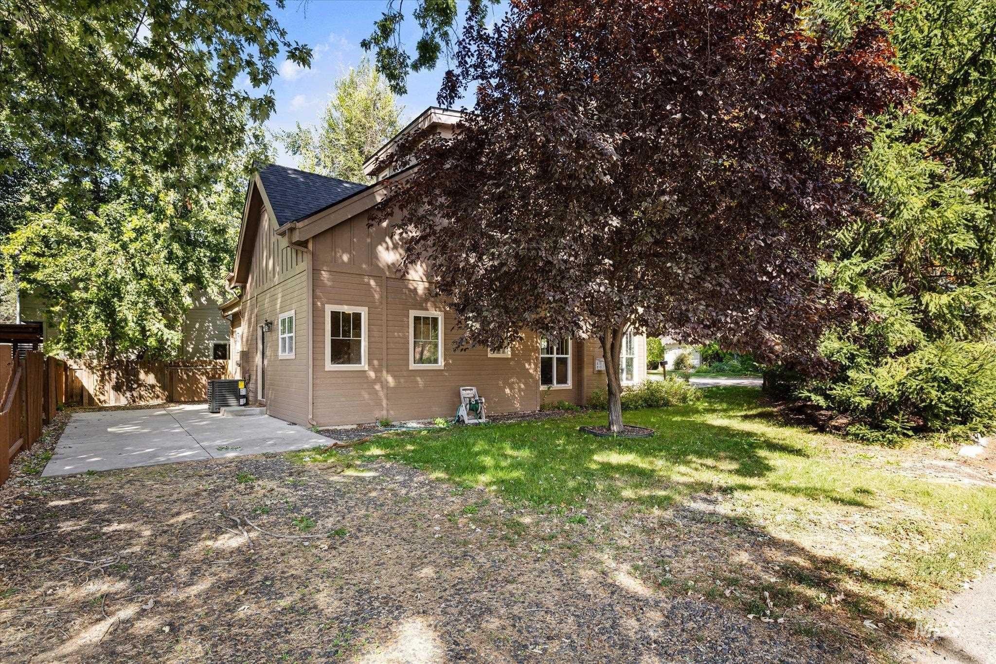 Back of house featuring a patio area and board and batten siding