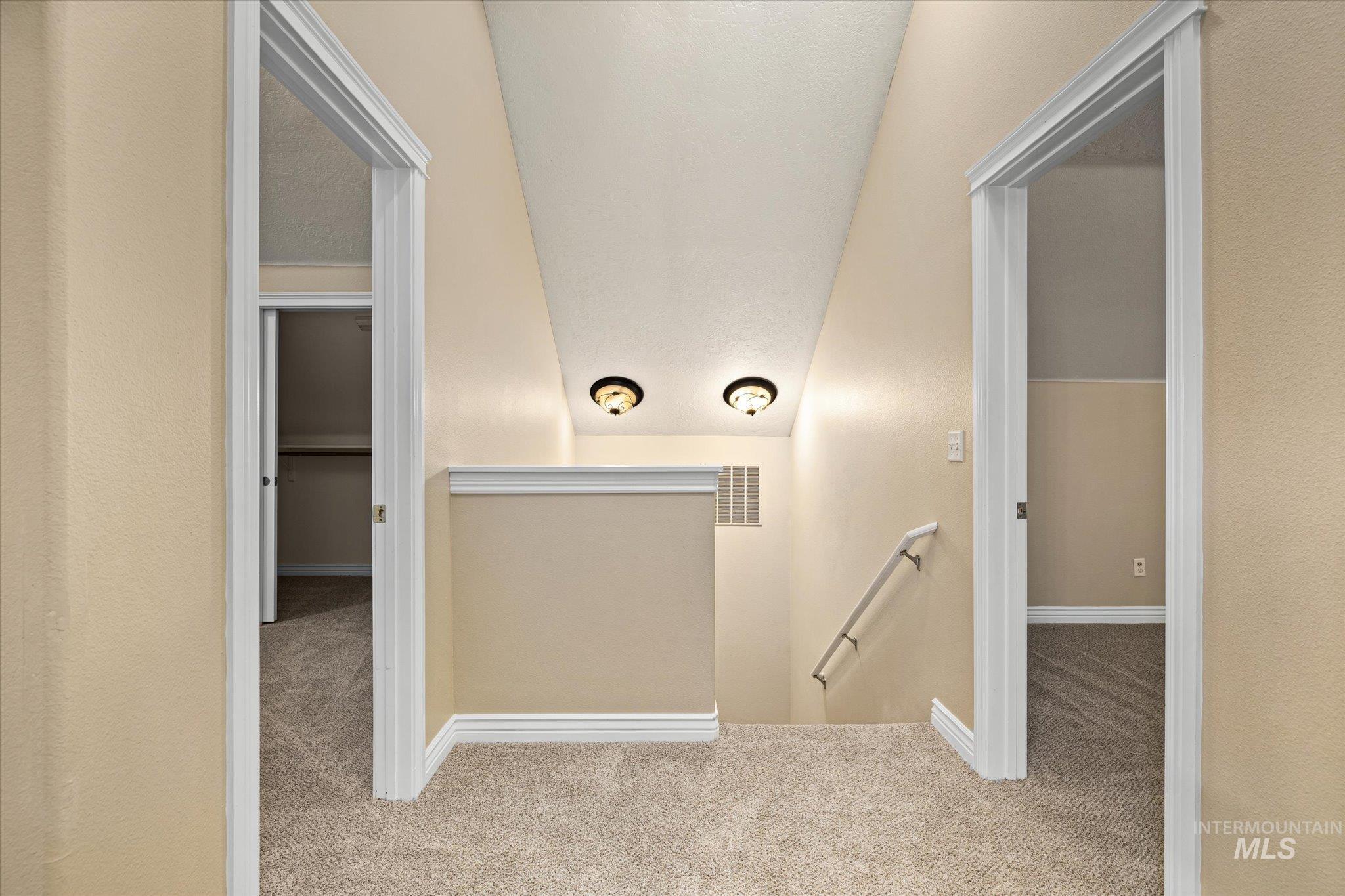 Hall with an upstairs landing and carpet