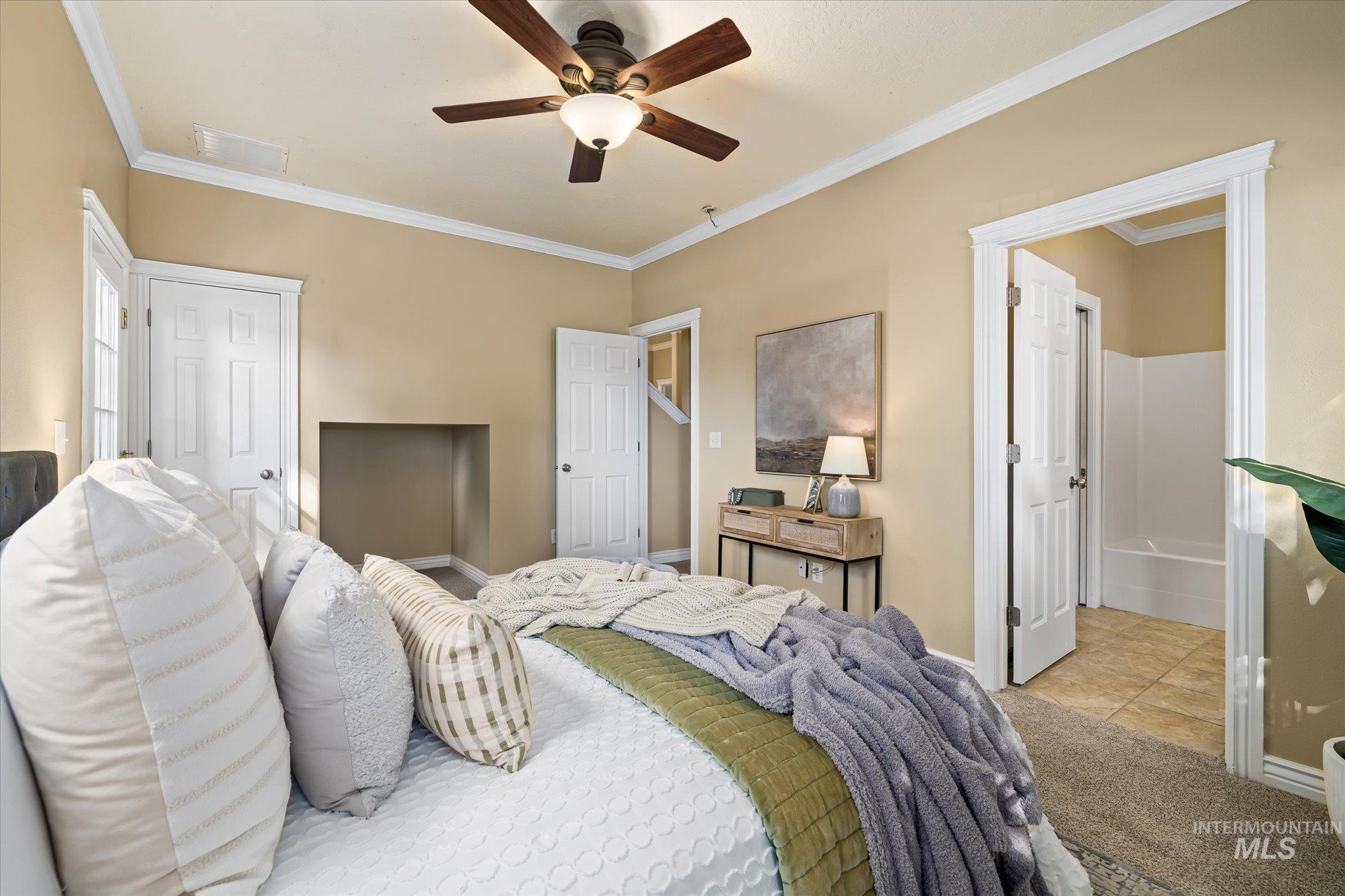 Bedroom with crown molding, tile patterned floors, and a ceiling fan