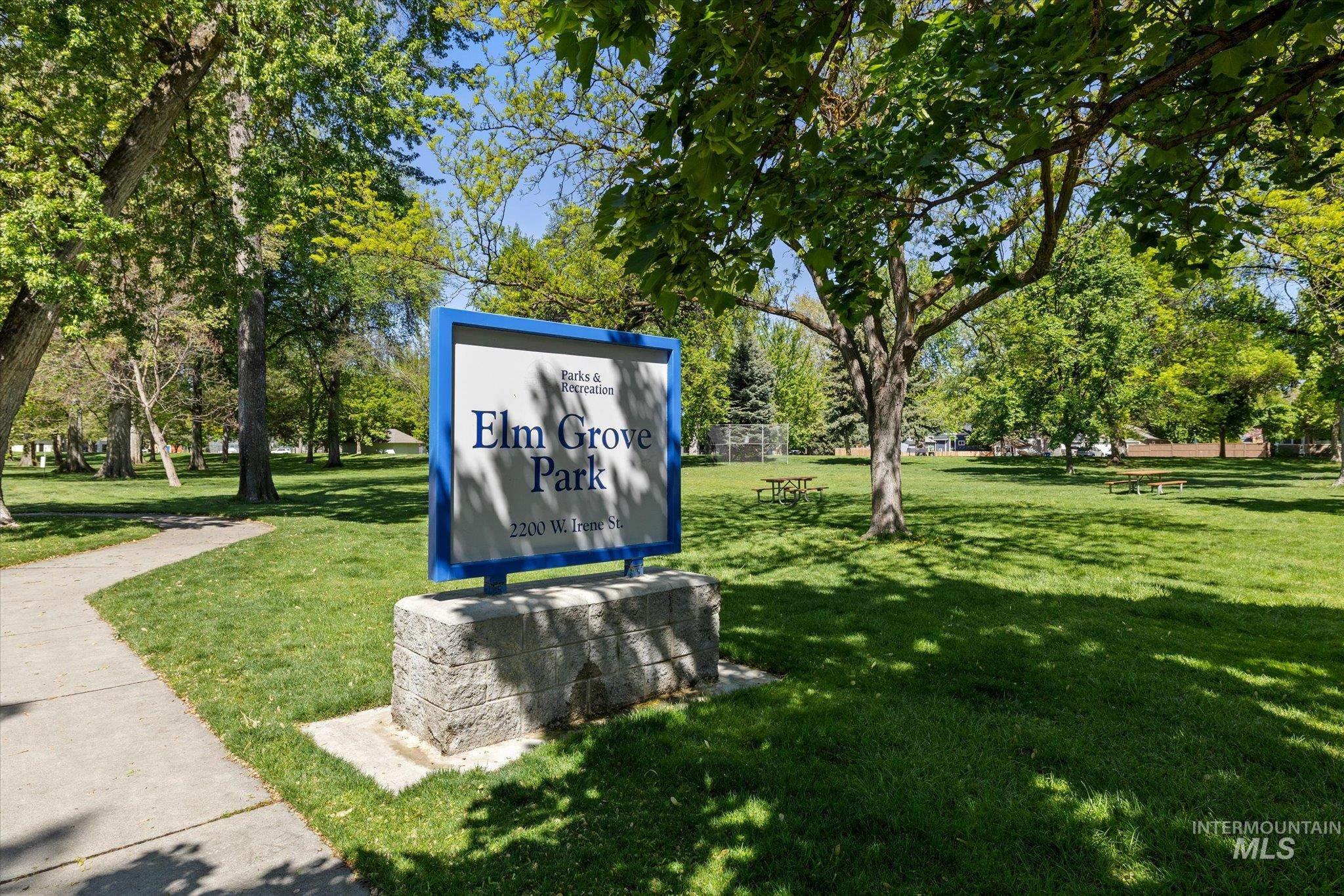 Surrounding community featuring a lawn and view of wooded area